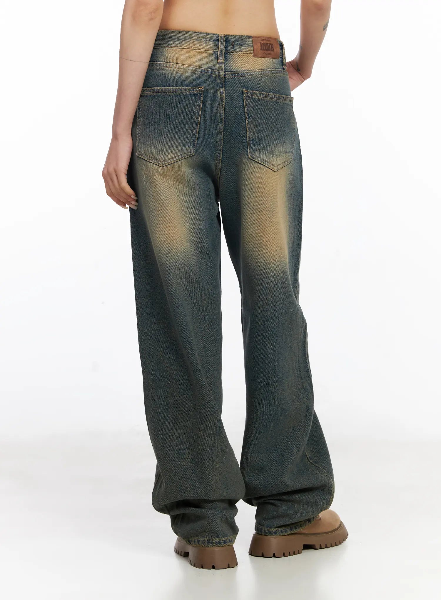 Karsyn Vintage Baggy Jeans CJ522 in dark blue, back full-length on model, wide baggy leg with vintage amber fade, dual back pockets, and hem pooling at brown boots.