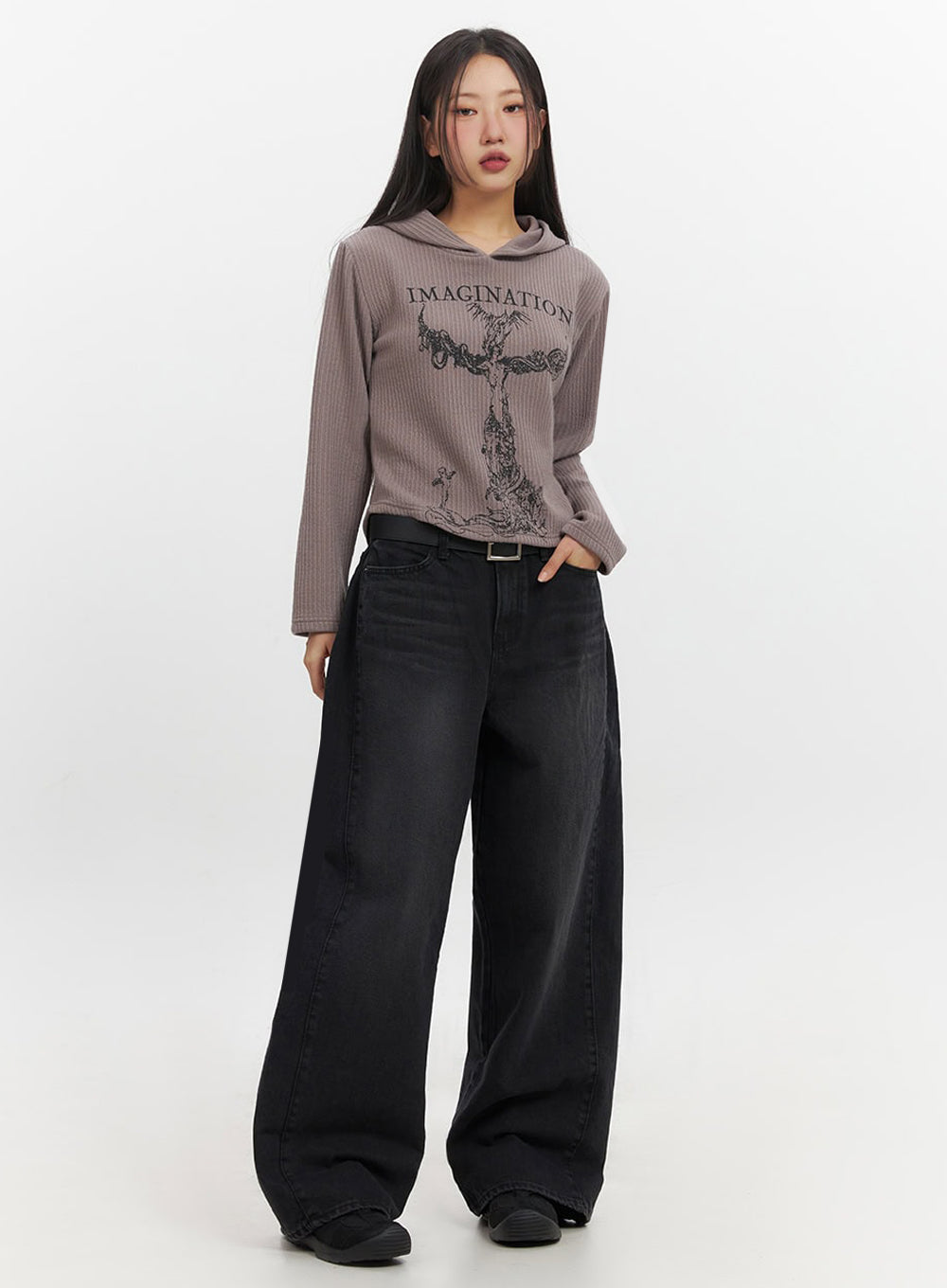 Ashly Wide-Leg Jeans IF511 in washed black, front full-length on model in slight turn, baggy wide-leg fit with black belt, styled with cropped graphic hoodie and sneakers.
