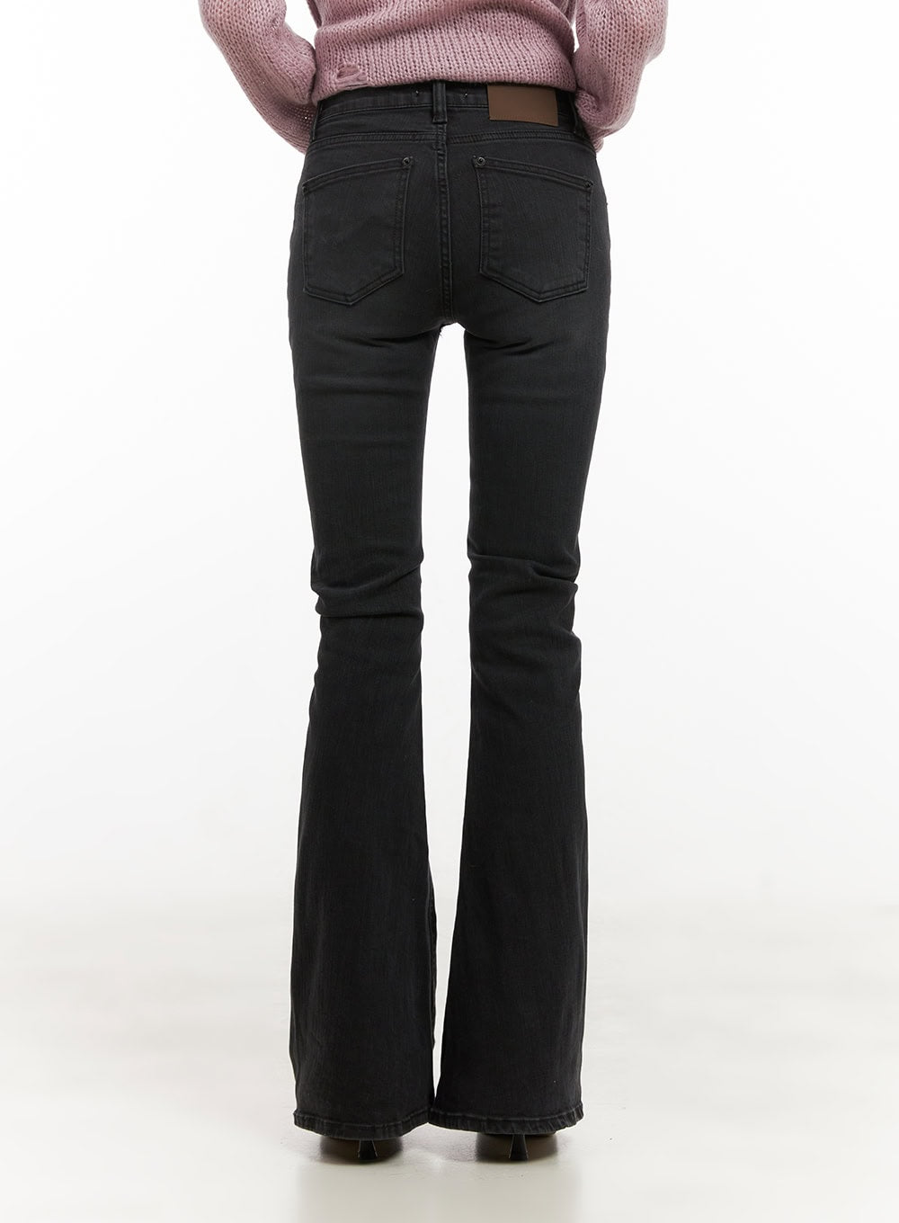 Belle Slim Fit Flared Jeans CD410 in black, back view on model, rear pockets and leather patch detail visible, slim fit through seat with flared hem, washed denim.