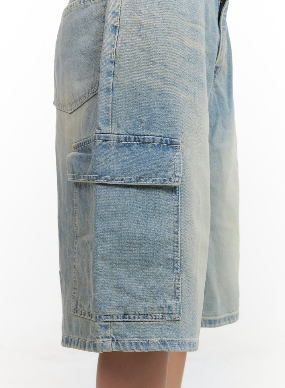 Cargo Baggy Jorts CL431 in light blue, detail close-up of side cargo pocket, washed cotton denim showing flap pocket stitching and faded wash texture.