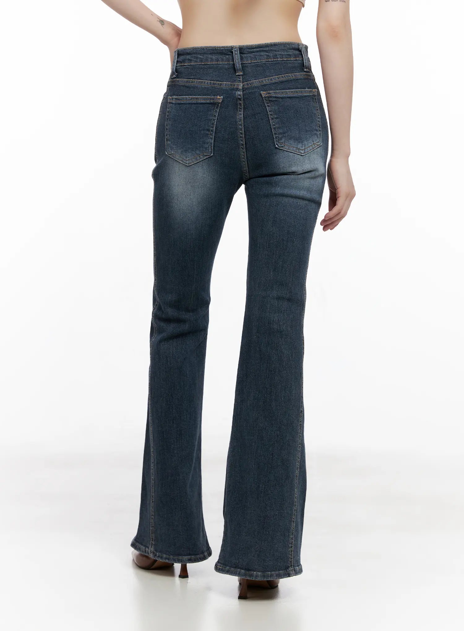 Giana High Waist Hip Pad Flare Jeans CG519 in blue, back view on model, showing back pockets, hip-enhancing pad shaping, washed denim, and flared hem.