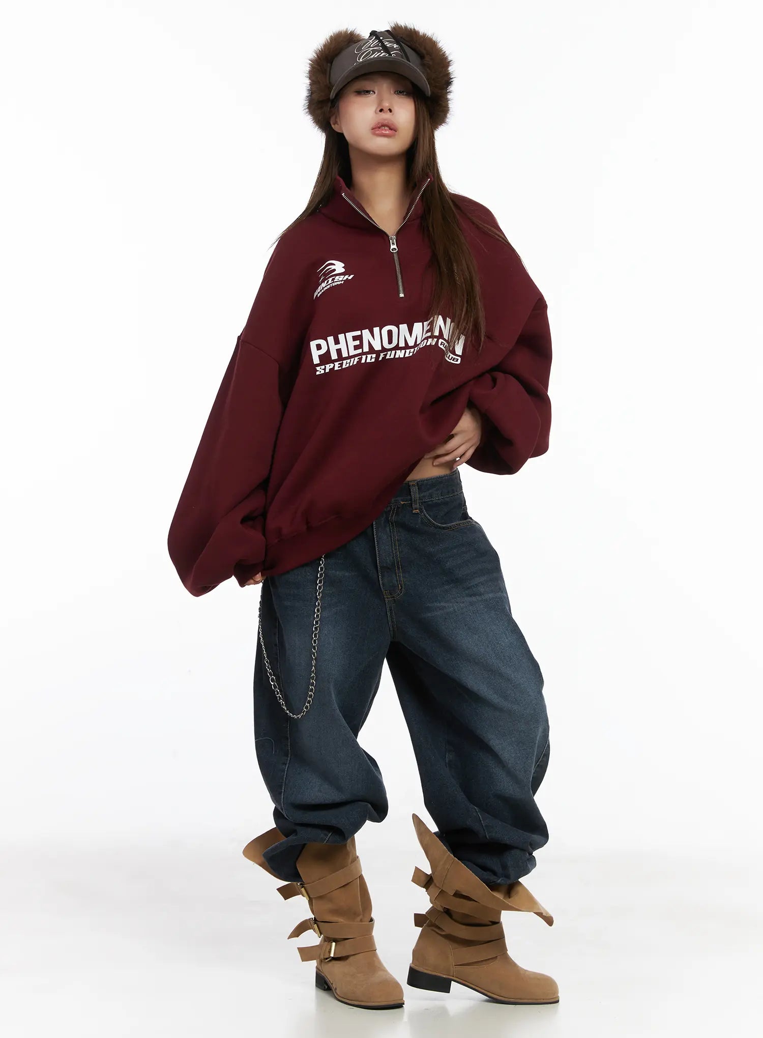 Everly Wide Leg Jeans CJ513 in dark blue, full-body editorial front view on model, wide fit washed denim styled with burgundy graphic sweatshirt, chain accessory, fur-trim cap, and tan bow boots.