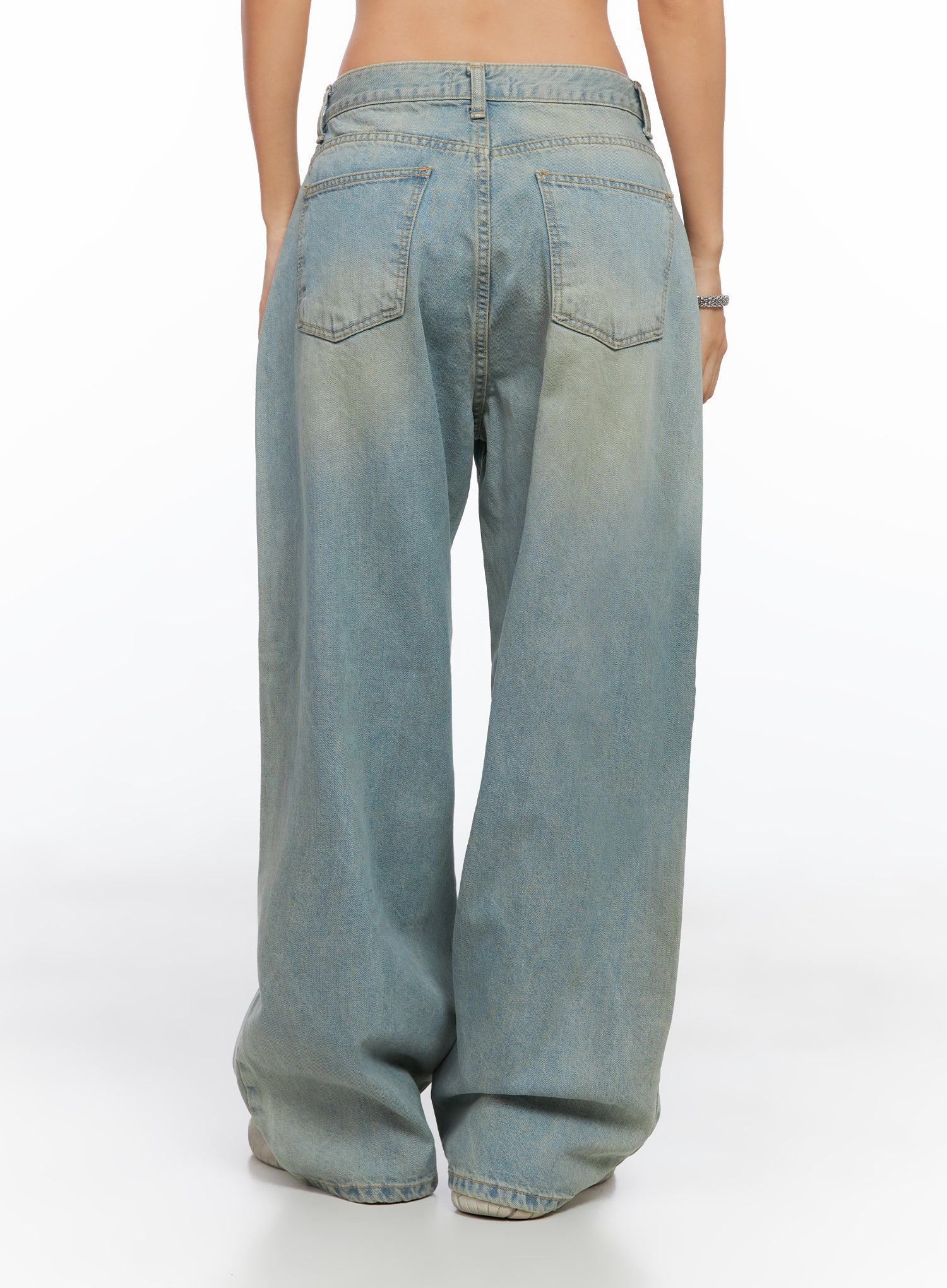 Remi Washed Baggy Jeans CO515 in light blue, full back view on model, wide baggy leg with washed cotton, back pockets and belt loop detail visible.