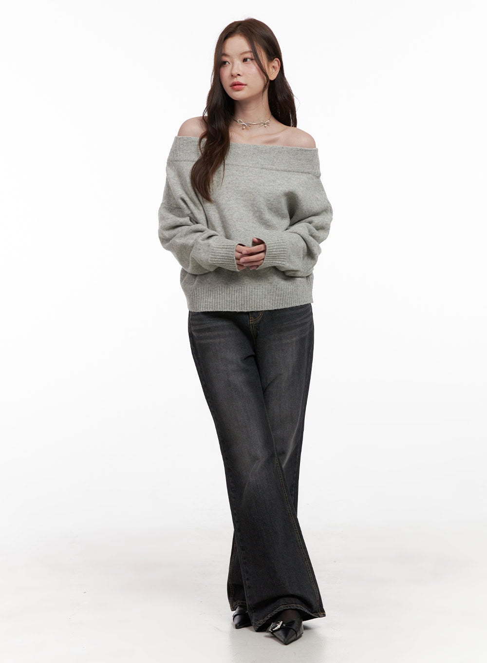 Kiana Cotton Wide Fit Flared Jeans OD403 in black, full-length slight-angle front view on model, washed wide-fit flared cotton denim, casual styling with grey off-shoulder knit and black buckle heels.