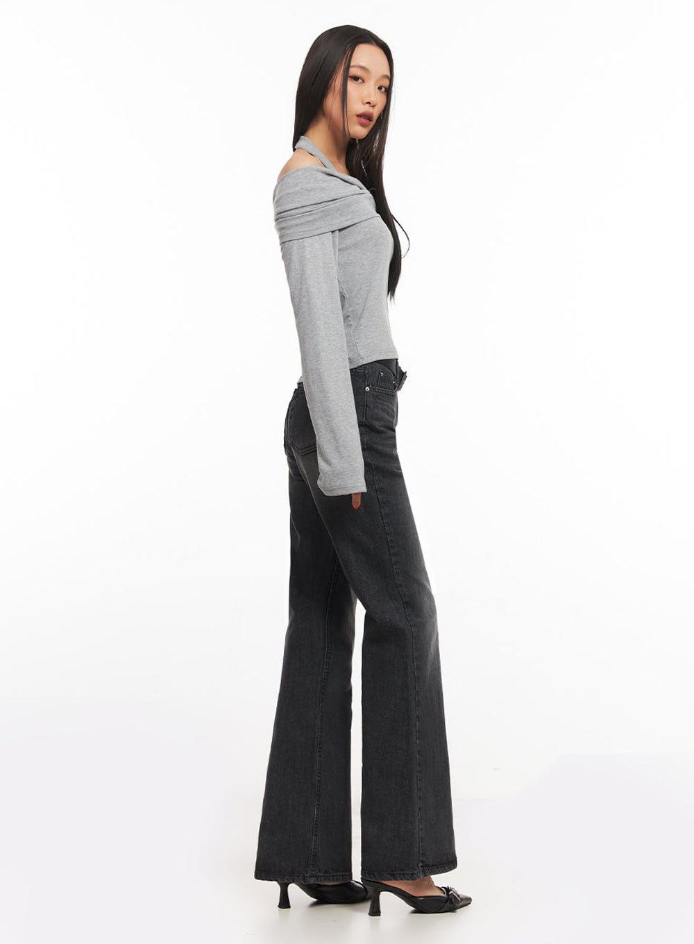Joanna Washed Flared Jeans IA504 in washed black, full side view on model, slim fit through thigh flaring to wide bootcut hem, high-rise waist, paired with grey off-shoulder top and kitten heels.