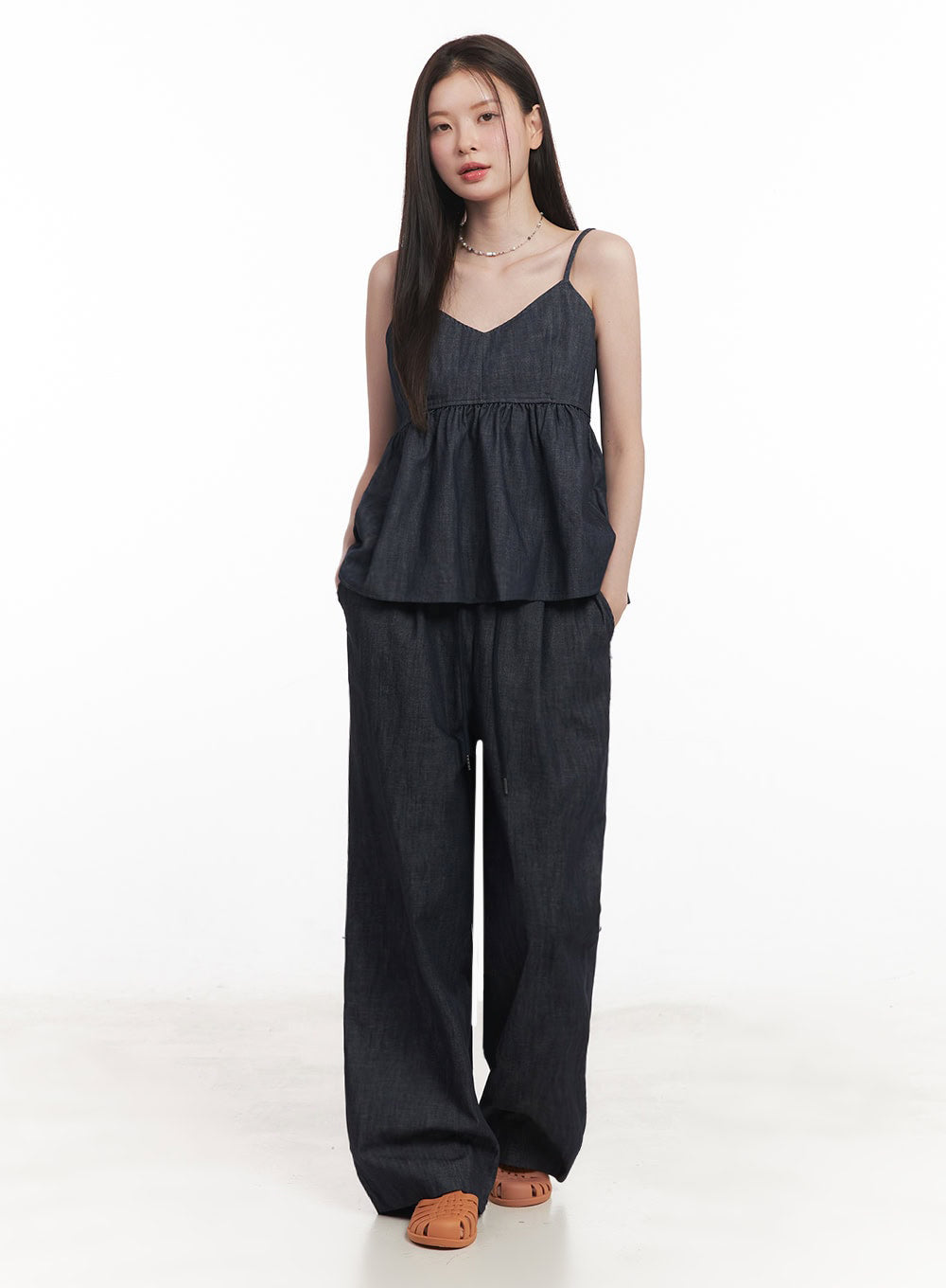Cotton Denim Wide-Leg Pants IY509 in dark navy, front full-body view on model with hands in pockets, relaxed wide fit and visible drawstring waist, styled with denim cami top and tan sandals.