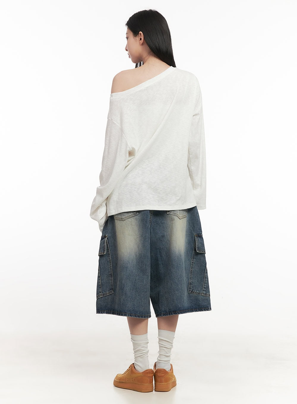 Cargo Bermuda Denim Shorts CF514 in dark blue, back view on model, wide-fit washed denim with dual cargo flap pockets at sides and back yoke detail, styled with white off-shoulder top.