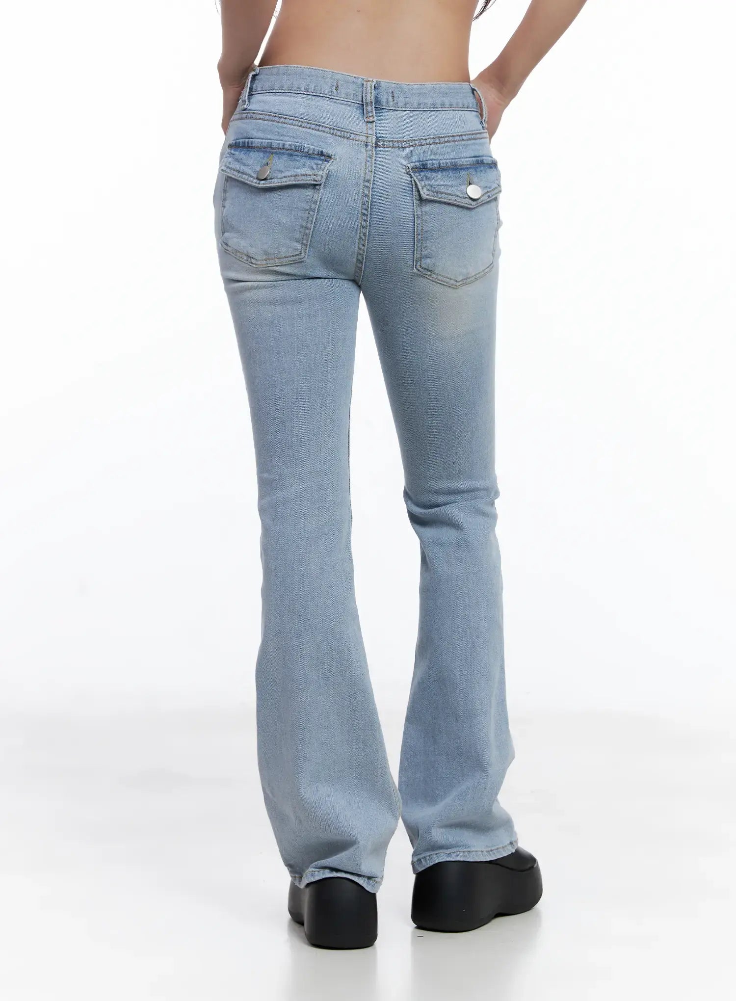 Yeojin Classic Flare Denim Jeans CL510 in light blue, back view on model, dual back pockets with snap buttons and washed finish, flare hem falls to floor, black platform sandals.