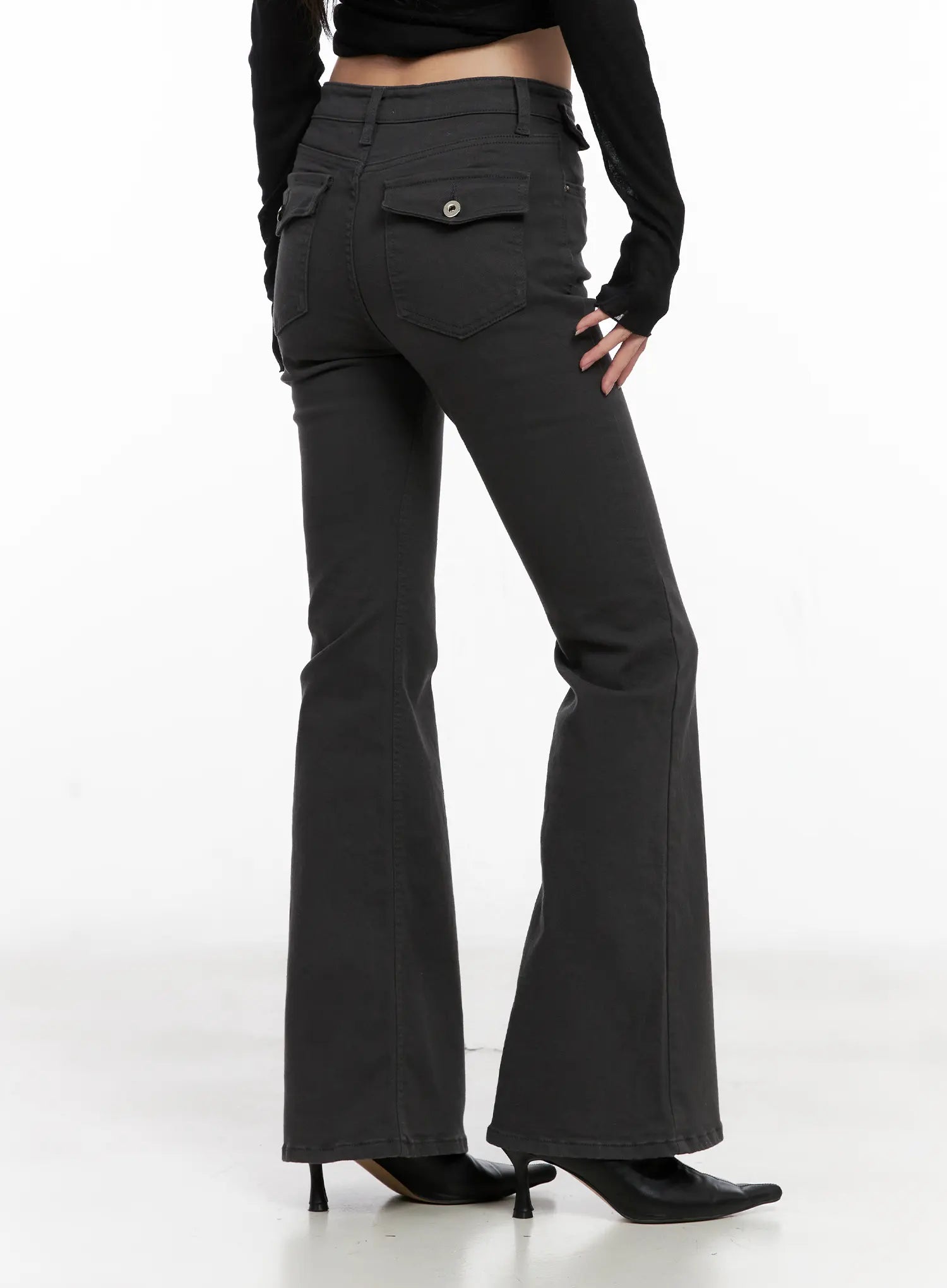 Addie Chic Flared Jeans CG522 in dark gray, close rear angle on model, dual flap back pockets with silver snap buttons highlighted, bootcut flare, mid-rise waist, cotton-spandex fabric.