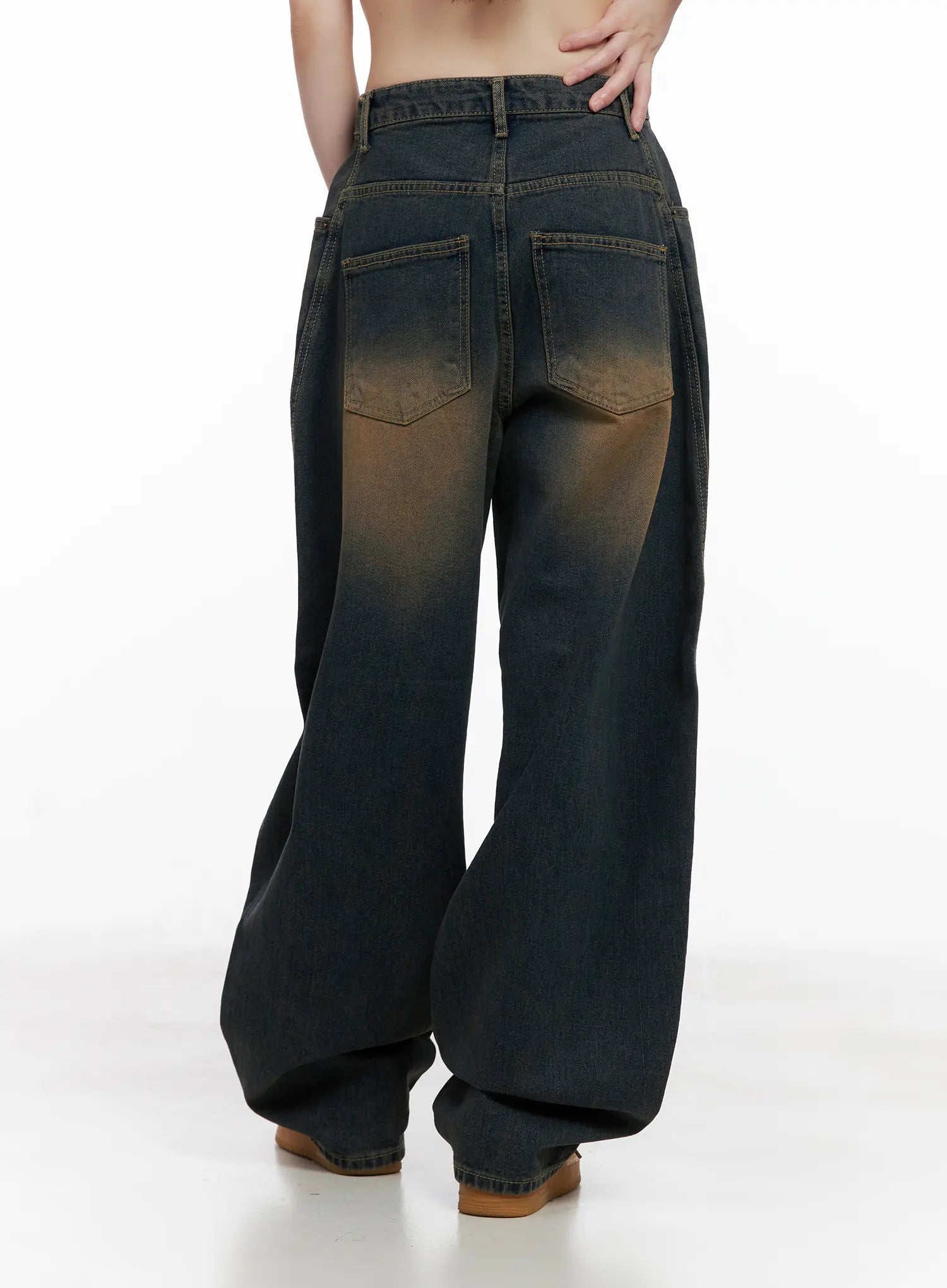 Jaycee Vintage Wash Baggy Jeans CG519 in dark blue, back view on model, showing back patch pockets, brown faded wash on seat, and wide-leg hem pooling at floor.