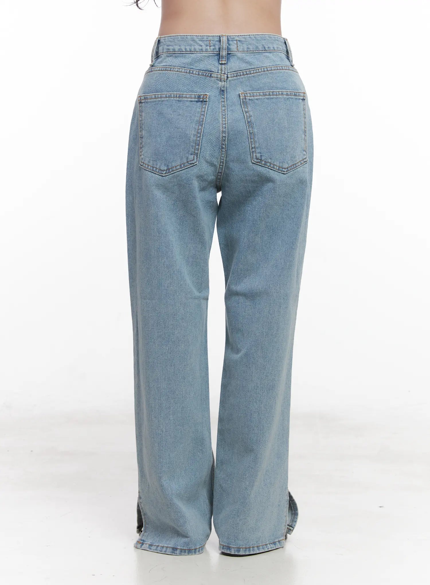 Hyuna Slit Straight-Fit Jeans CU525 in light blue, back view on model from waist down, showing dual back patch pockets and subtle hem slit, wide-fit washed denim.