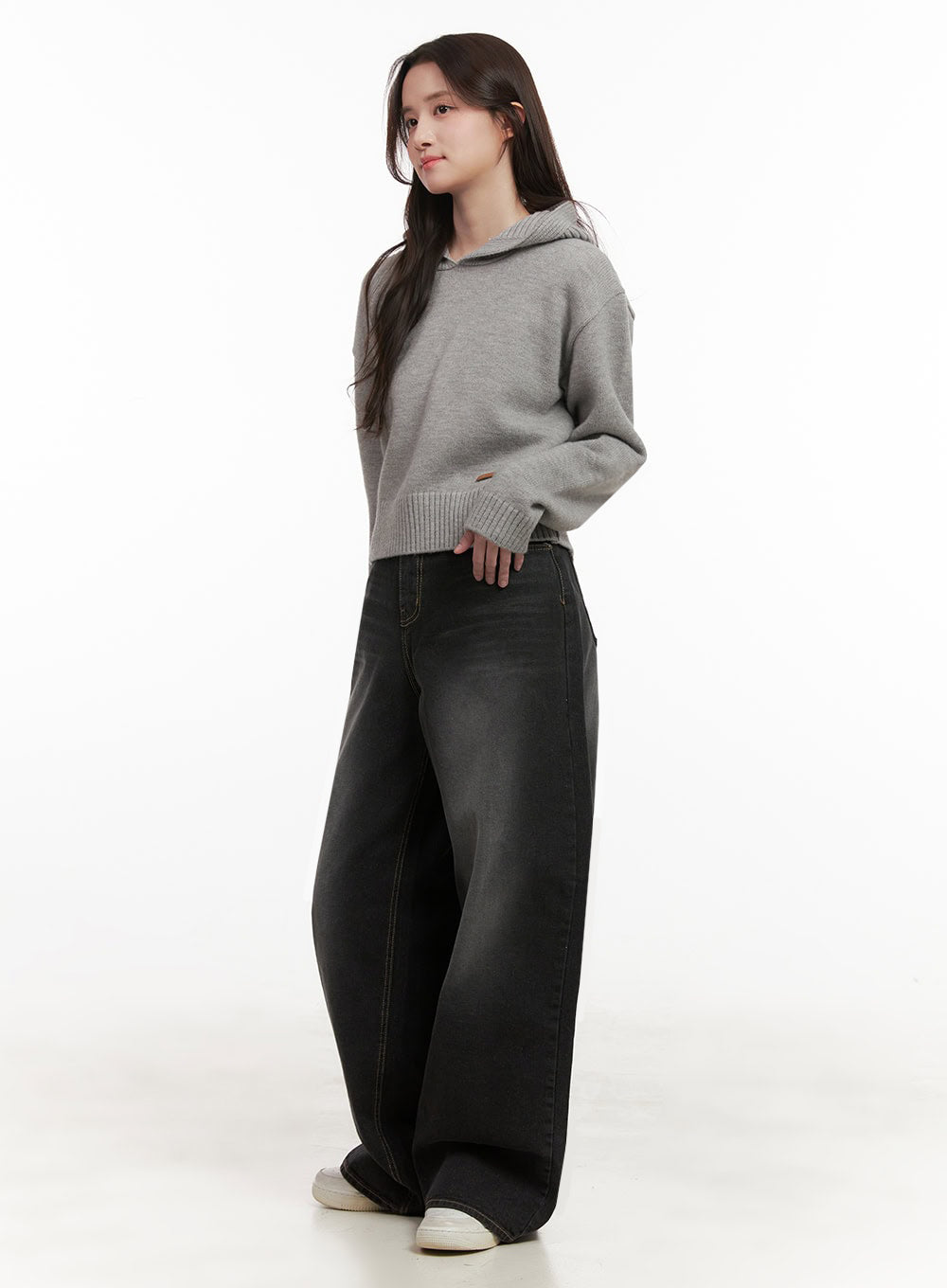 Christina Washed Baggy Jeans IJ510 in black, full-body side profile on model looking back, wide-leg silhouette length and washed gradient visible, styled with grey knit hoodie.
