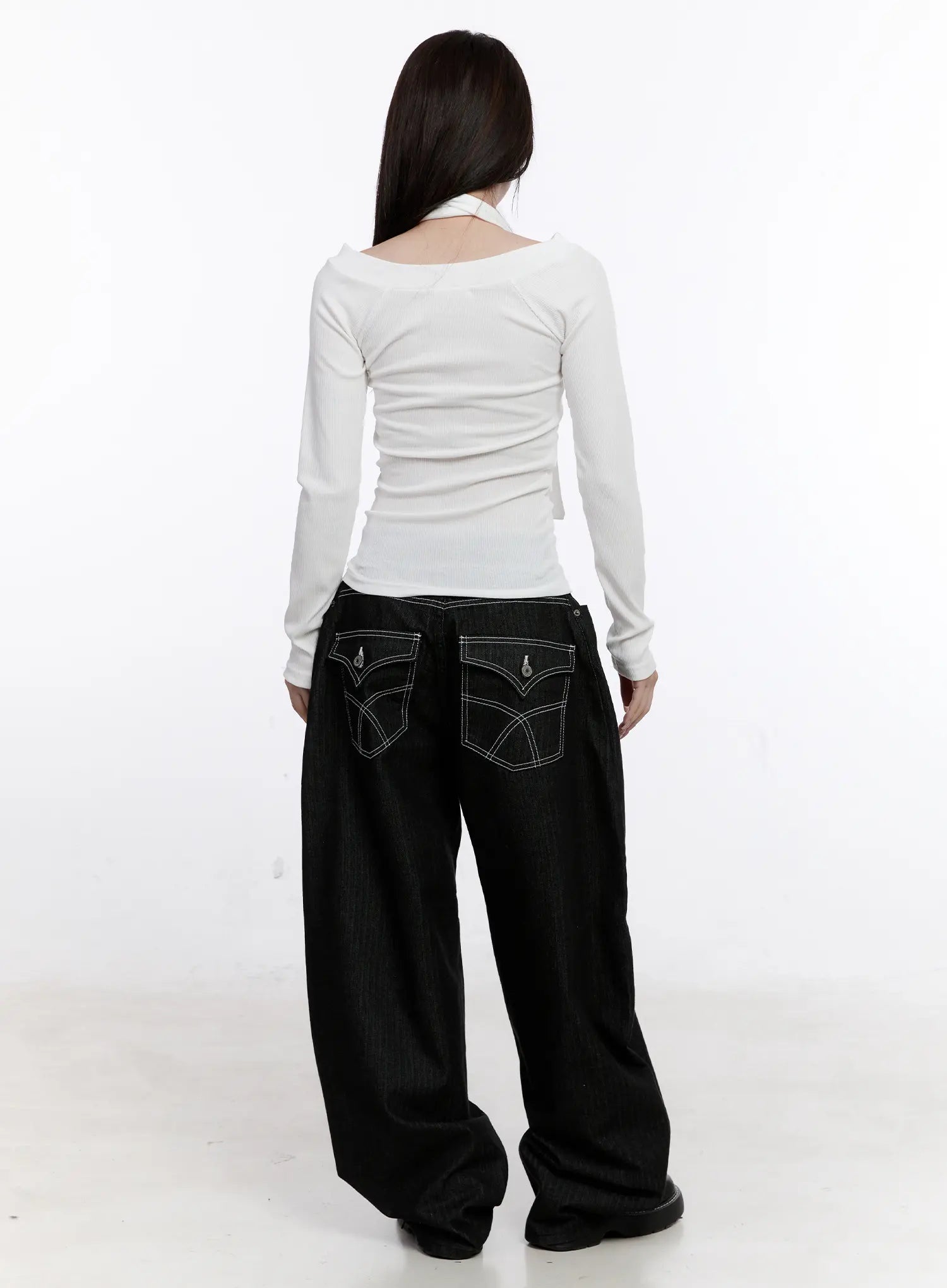 Vada Stitched Wide Leg Jeans CS530 in Black, back full-body styled shot on model, contrast-stitched curved back pockets visible, paired with white long-sleeve top and black platform shoes.