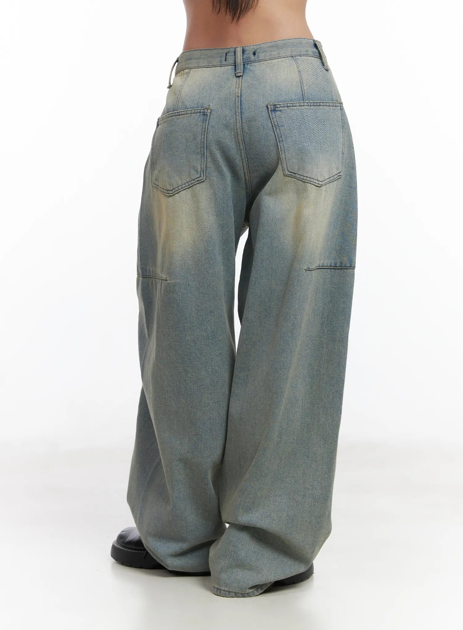 Lyla Washed Wide Leg Jeans CD530 in light blue, back three-quarter view close-up on model, dual back patch pockets with topstitching, washed denim fading detail and wide leg hem.