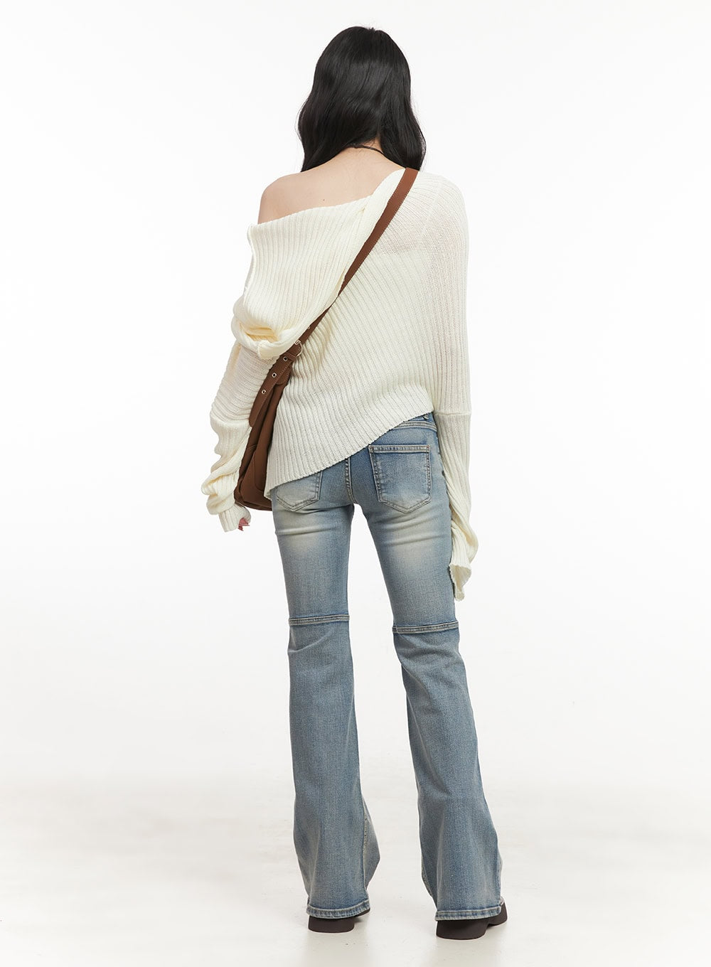 Tracy Washed Bootcut Jeans CF513 in light blue, back full-body styling shot on model, paired with oversized cream ribbed off-shoulder knit and brown crossbody bag.