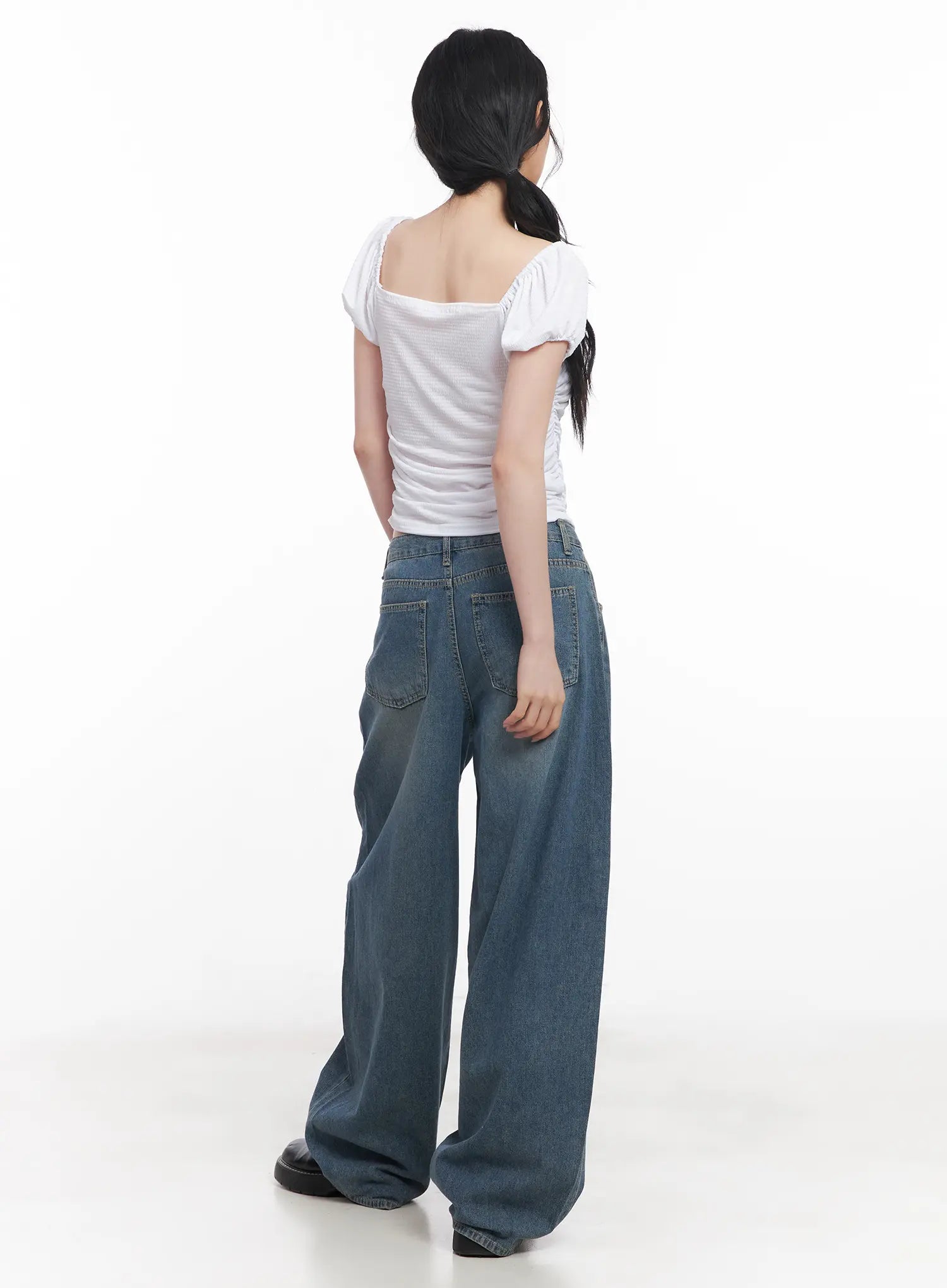 Chaewon Washed Wide-Leg Jeans CU511 in blue, full back view on model styled with white square-neck puff-sleeve crop top, back pockets and wide-leg silhouette visible.