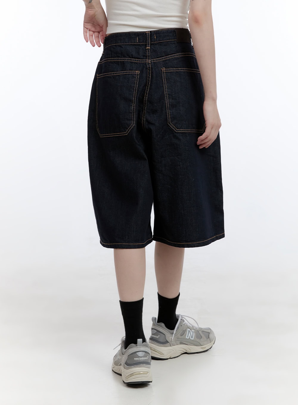 Dora Stitched Baggy Jorts CG413 in dark blue, back waist-down shot on model, featuring large square back pockets with bold contrast stitching and wide baggy silhouette.