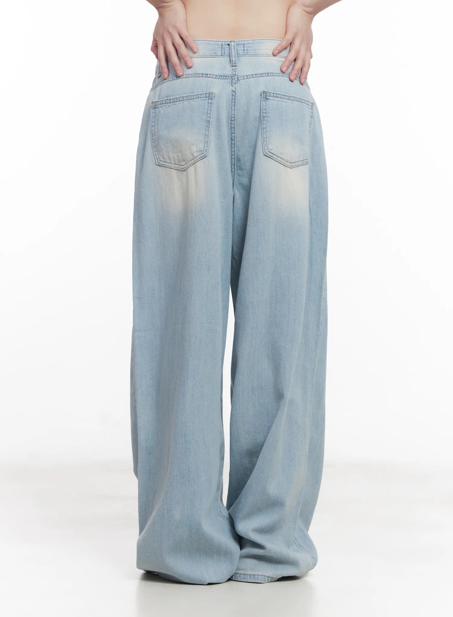 Garam Washed Wide-Leg Jeans CU518 in light blue, back close-up on model, dual patch pockets with arrow stitching, washed sun-faded denim, extra-wide leg drape.