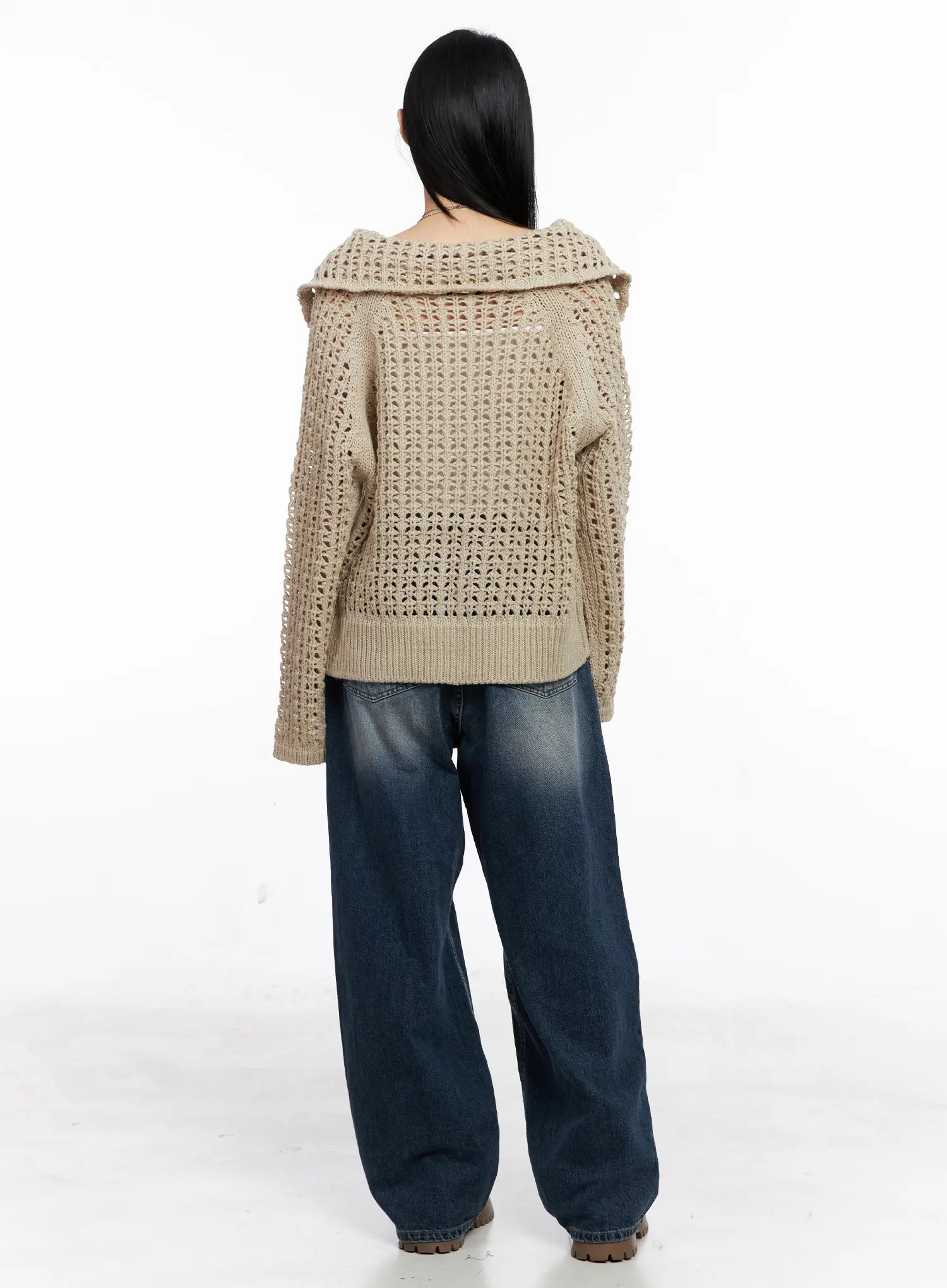 Aisha Washed Baggy Jeans CC1109 in mid blue, back full-length shot on model, wide-fit long denim with subtle washed gradient, paired with beige open-knit sweater and chunky boots.