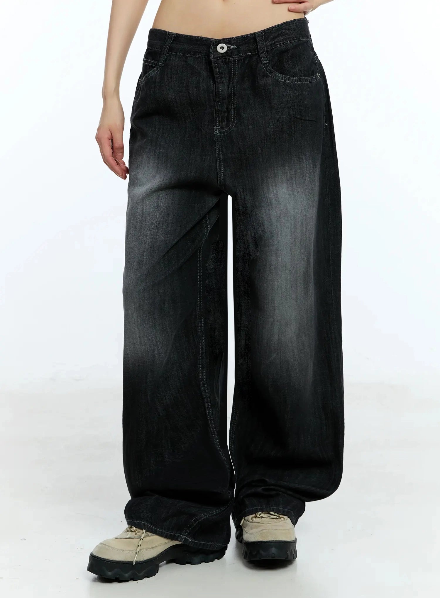 Wendy Washed Wide-Leg Jeans IU524 in black, waist-to-hem front shot on model, washed grey highlights across thighs, five-pocket construction, wide pooling hem over chunky sneakers.