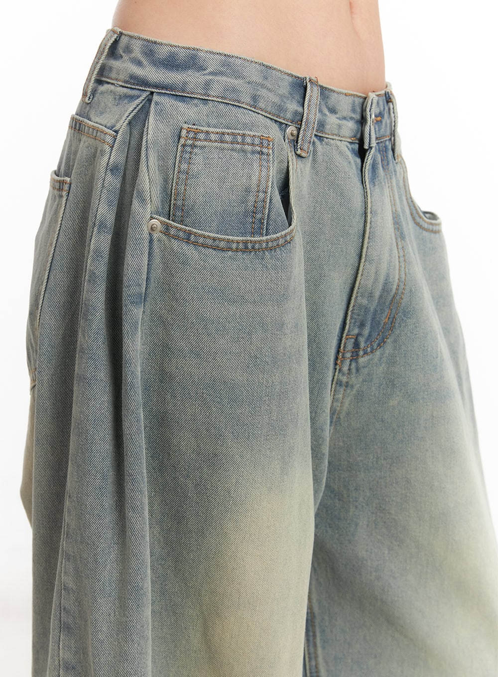 Hillary Washed Wide-Leg Jeans CM504 in light blue, waist detail close-up on model, showing pintuck pleat, front pocket stitching, and yellow-toned washed denim texture.