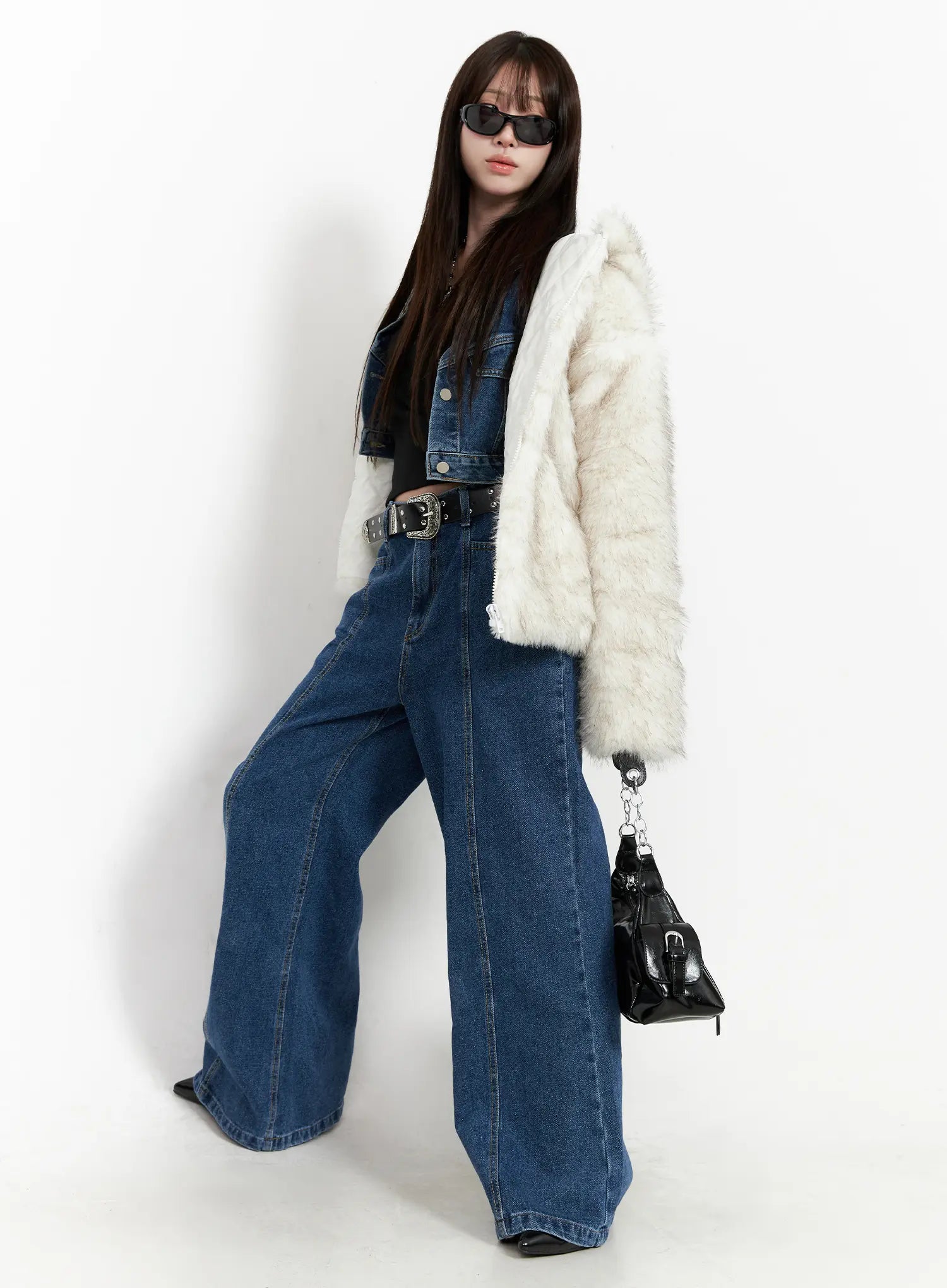 Eliza Seam Detail Relaxed Bootcut Jeans CO521 in washed blue, full-length on model, styled with cream faux-fur jacket, denim vest, black belt, and mini bag, front seam detail prominent.