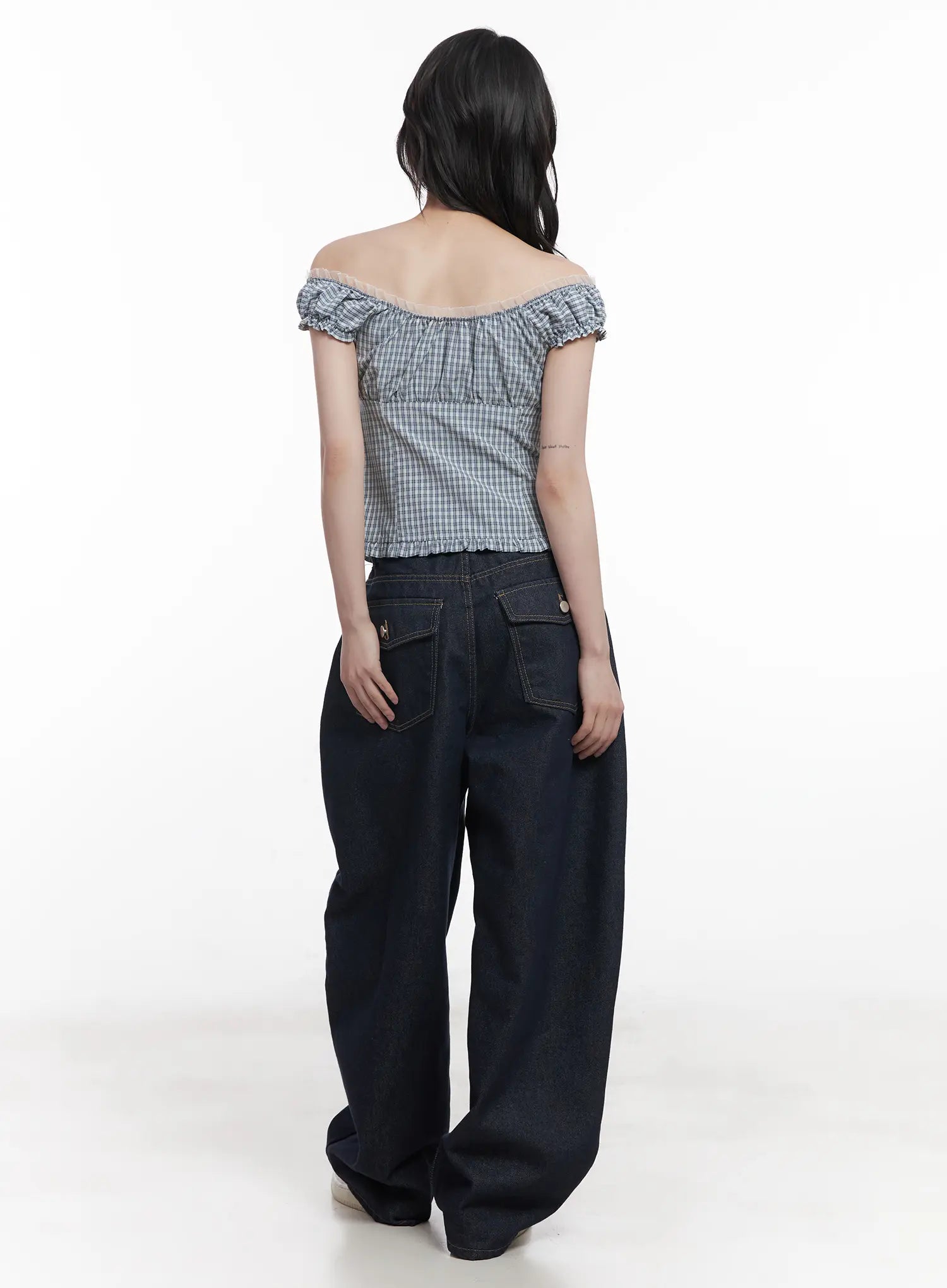 Hyein No-Fade Relaxed-Fit Jeans CU519 in dark blue, back full-length view on model, wide baggy denim with snap flap pockets, paired with gingham off-shoulder crop top.