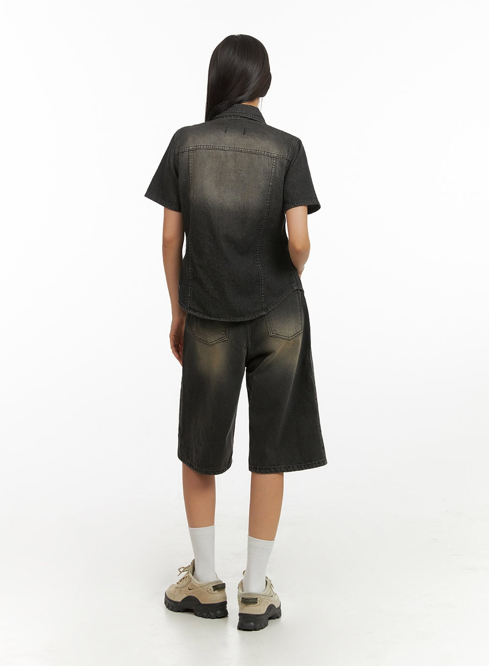 Color Washed Jorts IY422 in black washed denim, back view on model wearing denim-on-denim outfit, color-washed wide-leg jorts with dual back pockets and gradient faded finish.