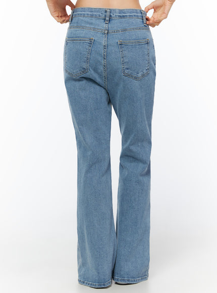 Leana Stretch Bootcut Jeans IU519 in blue, back full-length view on model, dual back patch pockets with gold topstitching, bootcut hem, washed denim.