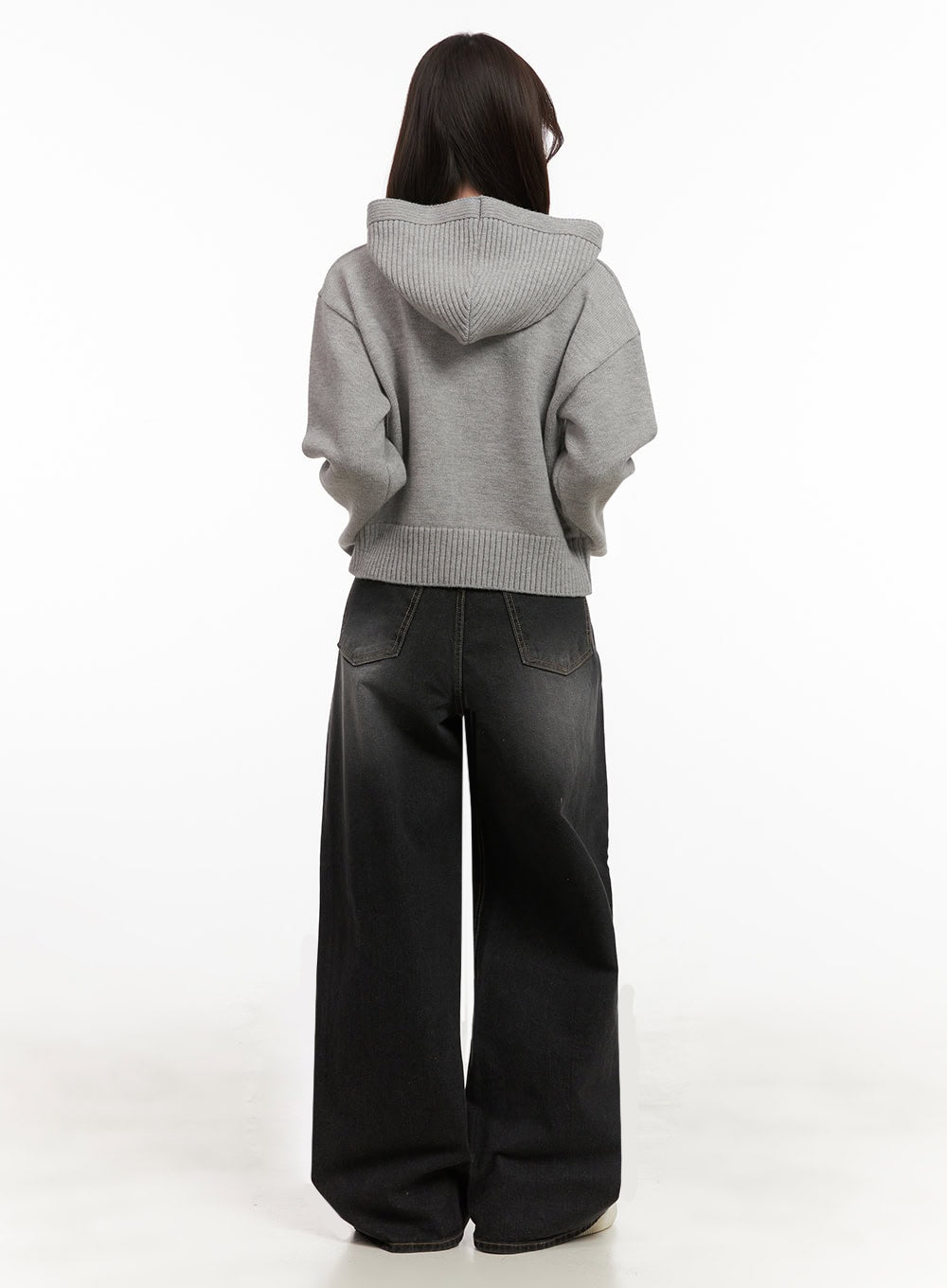 Christina Washed Baggy Jeans IJ510 in black, full-body back shot on model, back patch pockets and washed denim fade shown, paired with grey knit hoodie and white sneakers.