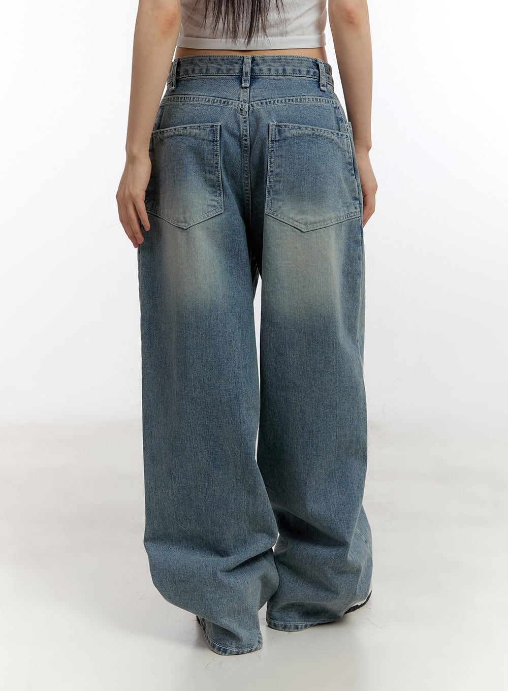 Jillie Washed Baggy Jeans CA508 in blue, back close-up view on model, washed denim featuring oversized back pockets with V-shaped stitching and subtle fading across seat and thigh.