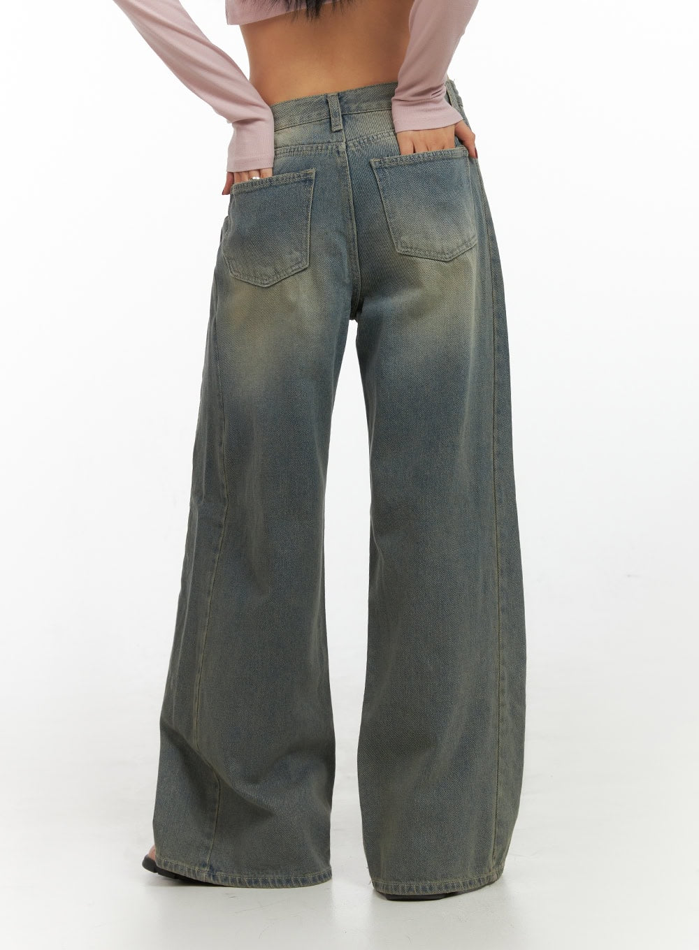 Inez Washed Denim Wide Leg Jeans IS427 in vintage green, back close-up on model, dual patch pockets and yellow-tinted washed denim detail, extra-wide leg hem visible.