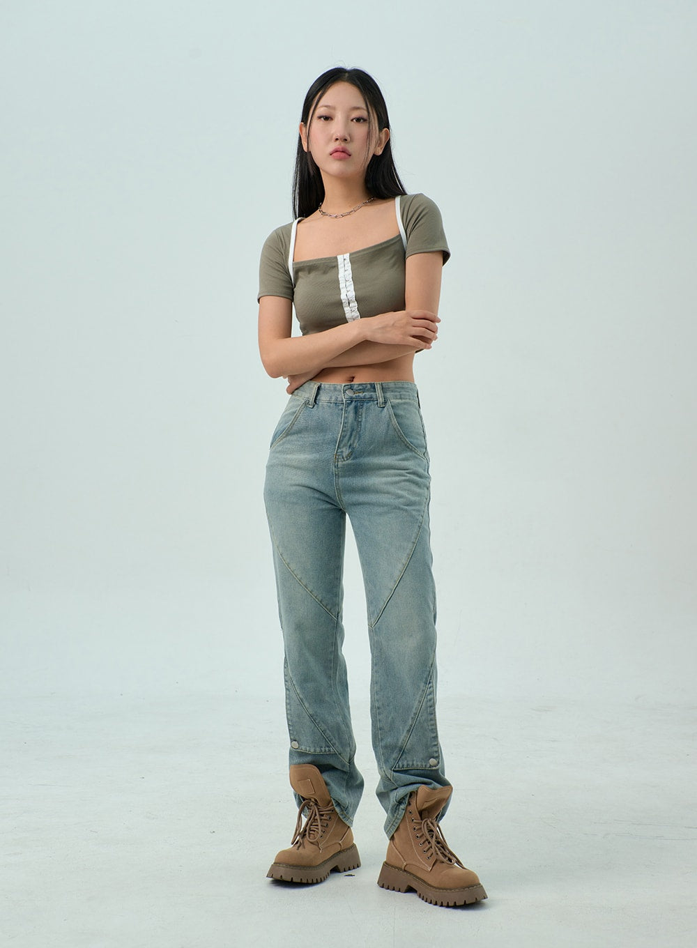 Straight Leg Jeans CY330 in light blue wash, full-length front shot on model with arms crossed, straight-fit cotton denim showing panel seams from hip to hem, styled with olive crop top.