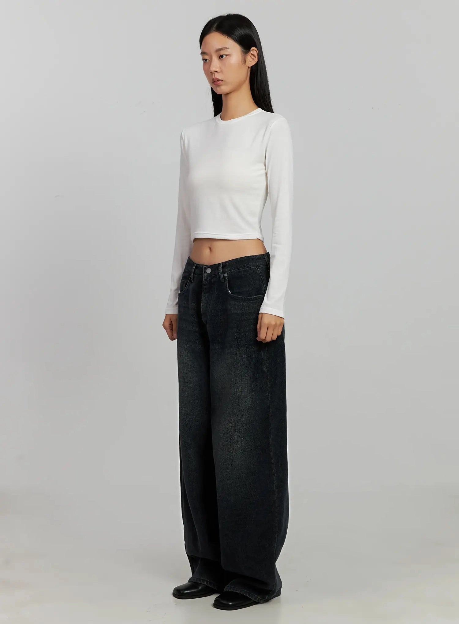 Aubree Washed Wide Jeans IJ502 in dark blue, full-length angled front shot on model looking to side, showing wide-leg volume and low-rise fit with white crop top styling.