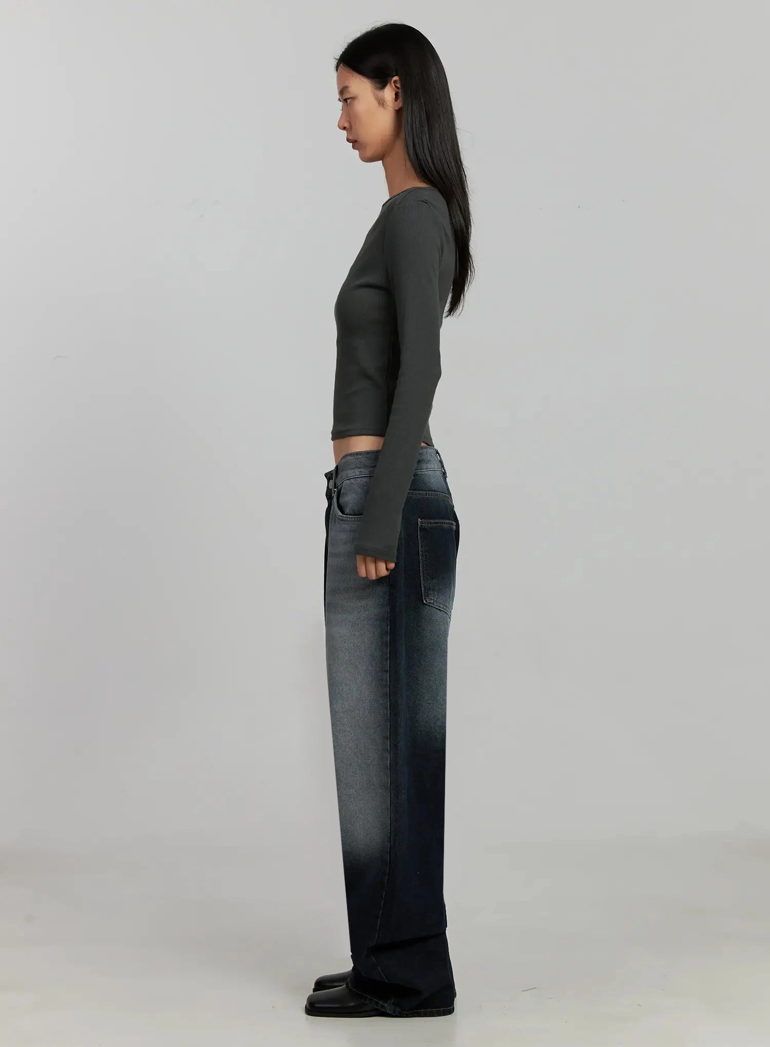Chaya Washed Wide Jeans IJ505 in dark blue, full side-profile view on model, showing long wide-leg silhouette with washed gradient and back pocket, paired with grey crop top.