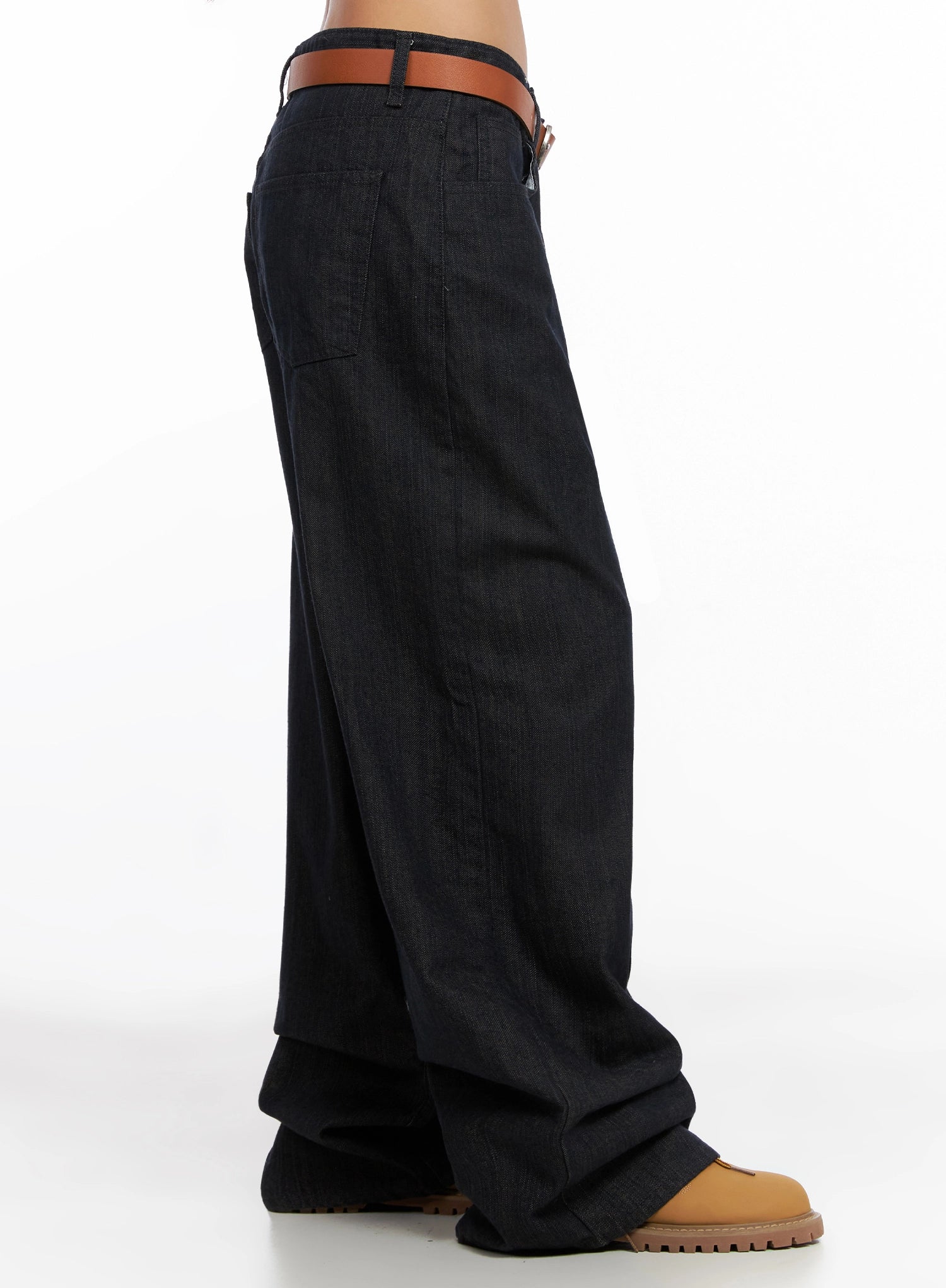 Heidi Wide-Leg Jeans IG527 in dark blue, pure side view on model from waist to floor, revealing exaggerated wide-leg sweep and back patch pocket, belted at low waist.