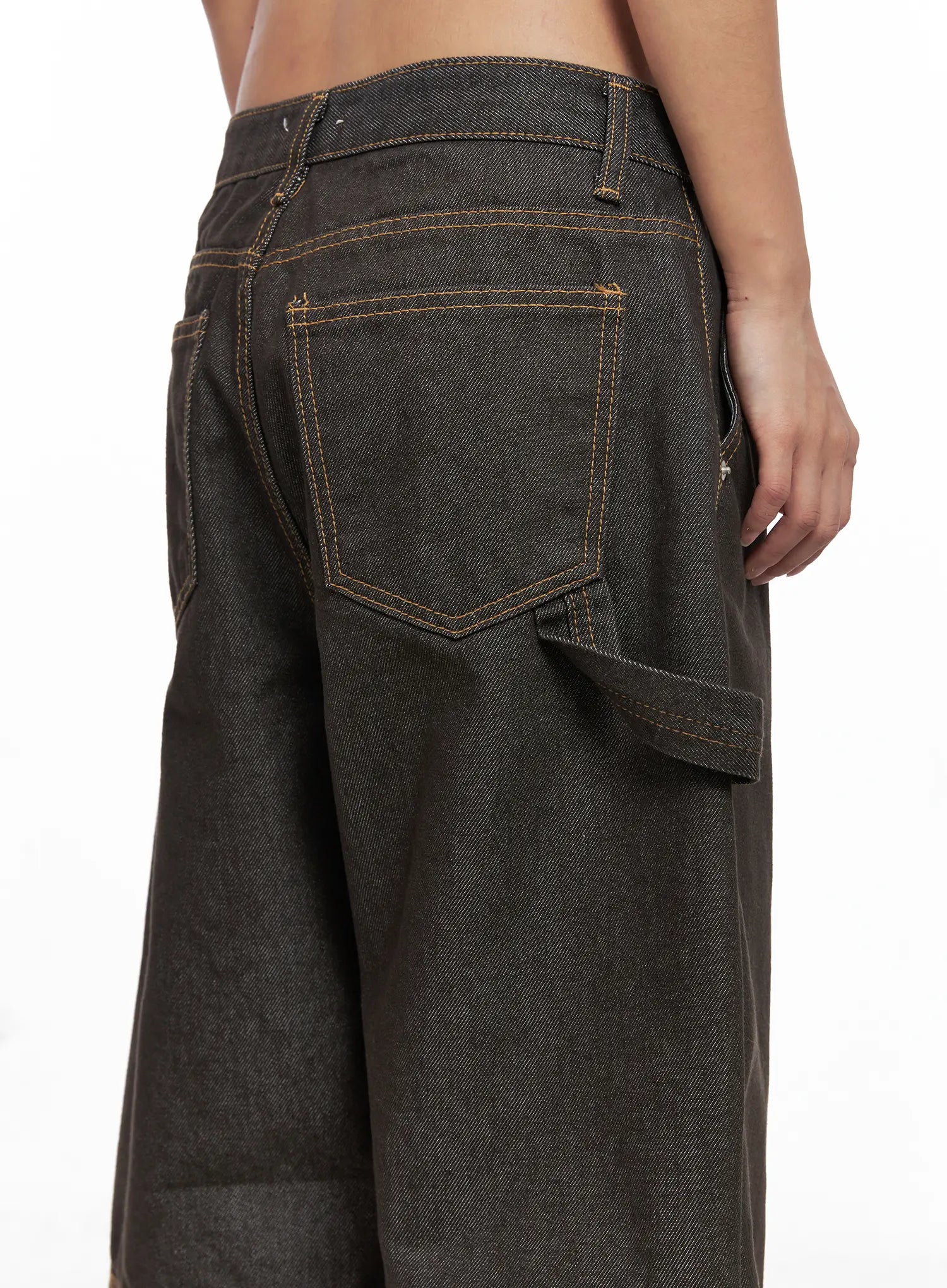 Oaklyn Non-Fade Wide-Leg Jeans CO513 in dark brown, close-up back waist and pocket detail on model, structured back patch pocket and carpenter strap with golden contrast topstitching.
