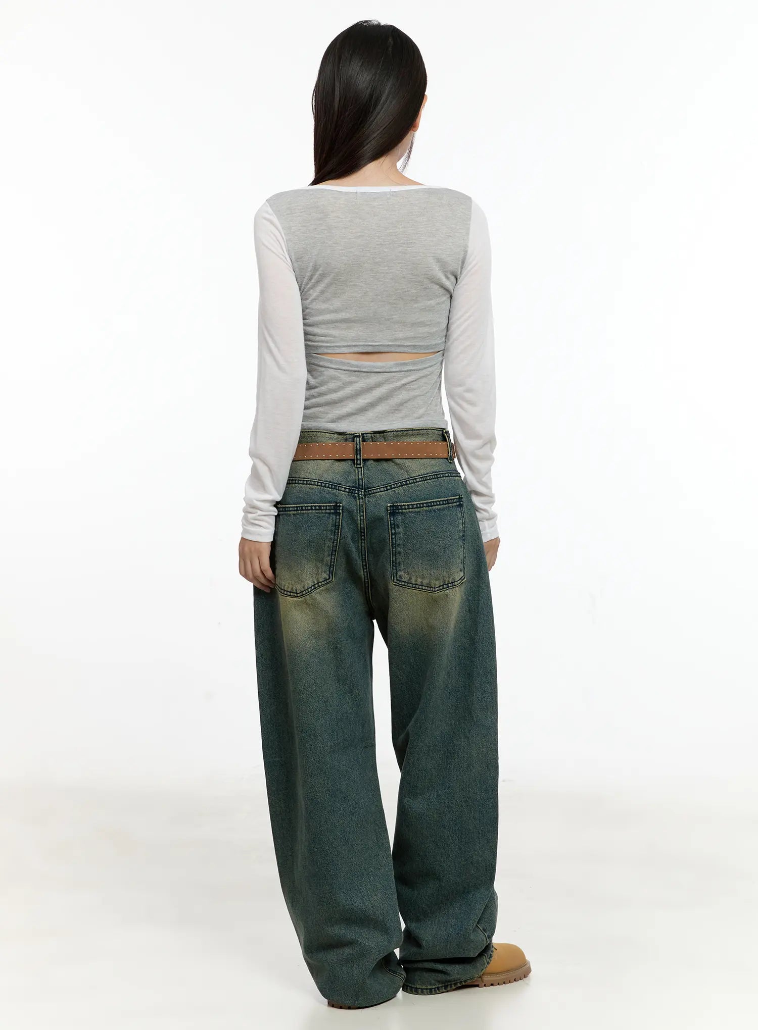Sooyoung Baggy Vintage Wash Jeans CL531 in dark blue, full-body back view on model, wide-leg silhouette with vintage wash gradient, belted, styled with crop top and tan boots.