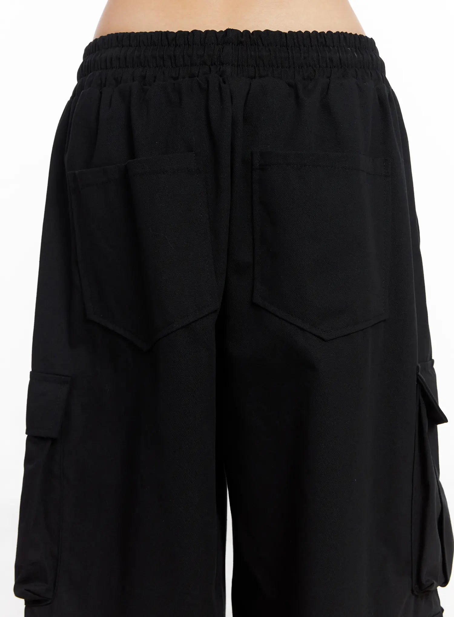 Wide Leg Cargo Pants CC1109 in black, back waist close-up, elasticated smocked waistband, two back patch pockets, side cargo pocket detail, cotton fabric.