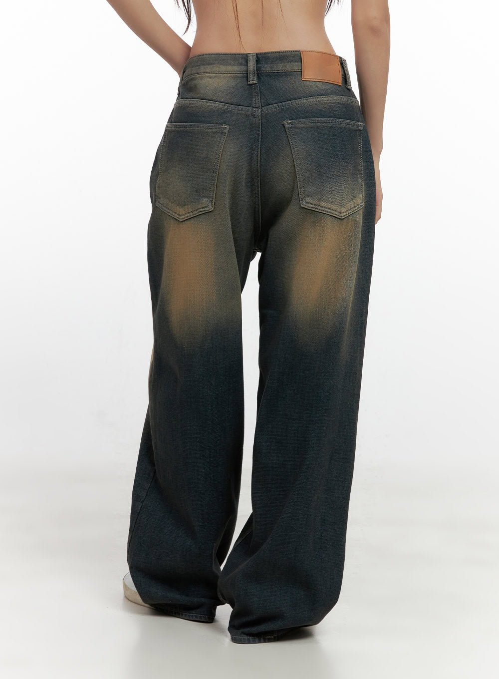Bryana Cotton Comfort Wide Leg Jeans CN419 in dark blue, back close-up on model, dual back pockets with tan leather patch label, amber-washed cotton denim, wide leg with draped hem.