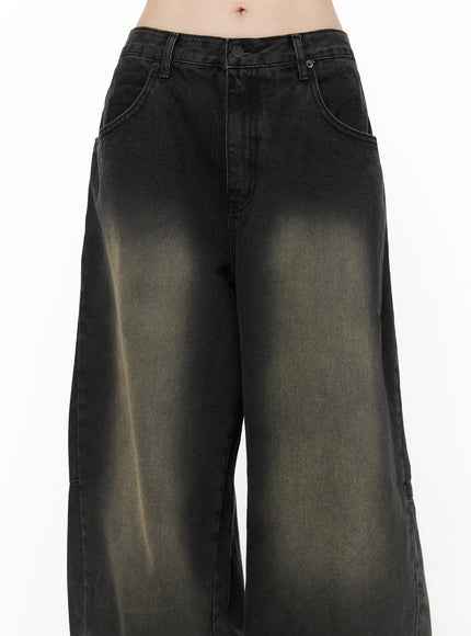 Bodie Vintage Wash Wide Leg Jeans CU519 in black, close-up front waist-to-thigh shot, button fly, front patch pockets, khaki sunfade vintage wash across wide leg denim.