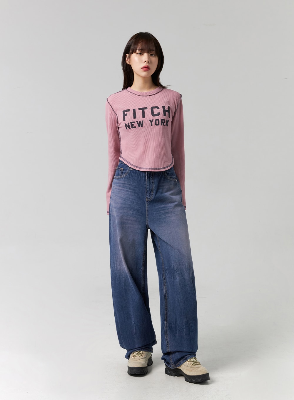 Wide Leg Cotton Jeans CG331 in blue, full front view on model standing straight, washed indigo cotton denim with wide barrel leg and high waist, styled with pink crop tee.