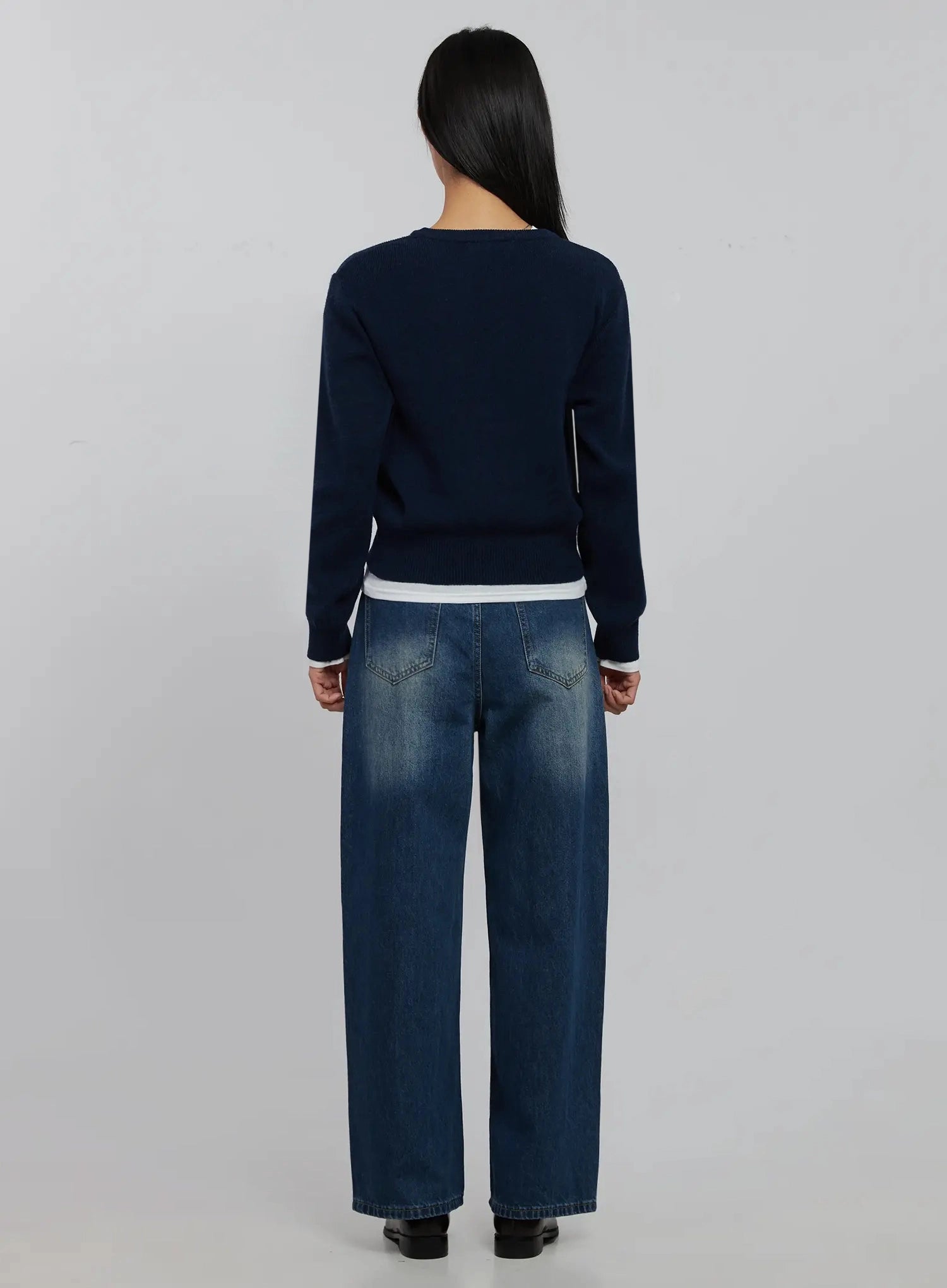 Alaina Wide Leg Jeans IJ508 in dark blue, full back view on model, back patch pockets with contrast stitching, washed wide-leg cotton denim, navy knit on top.