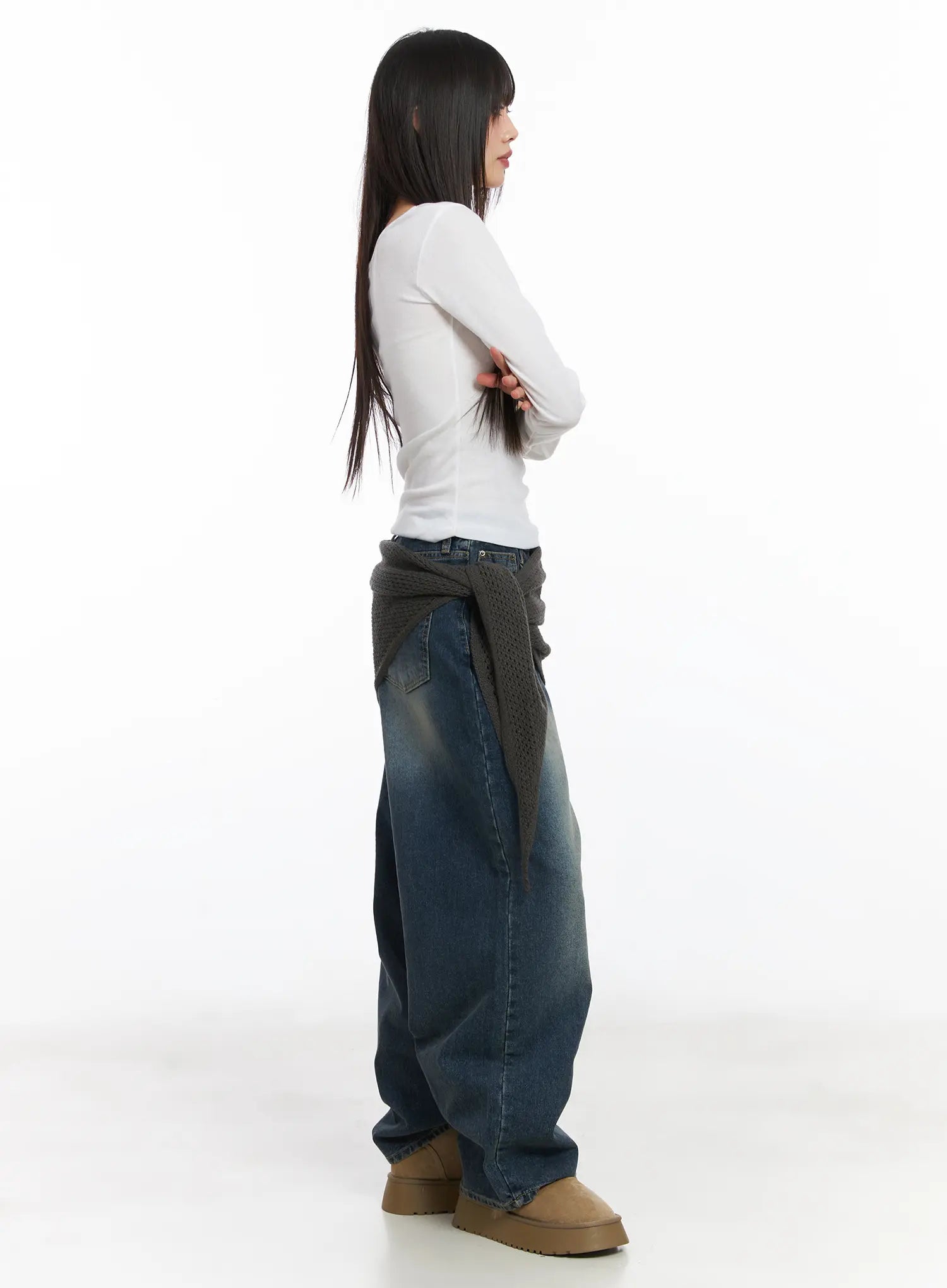 Eliza Fleece-Lined Washed Wide Leg Jeans CD518 in blue, side full-length view on model, washed wide-leg denim with relaxed drape, layered with knit wrap, arms crossed pose.