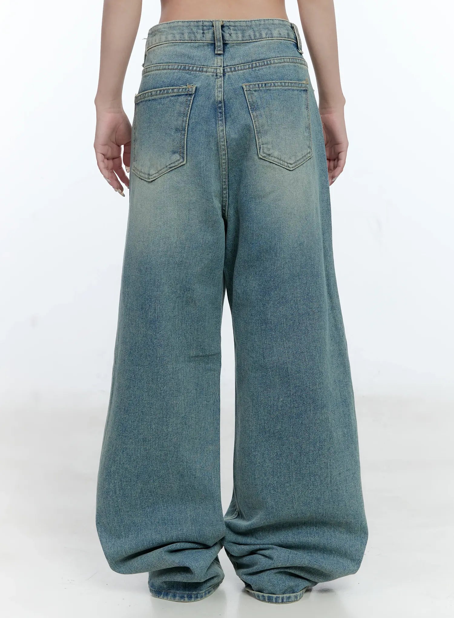 Haeun Wide-Leg Denim Jeans CG501 in blue, back view on model without top, full-length washed cotton wide-leg fit with dual back pockets and pooling hem at floor.