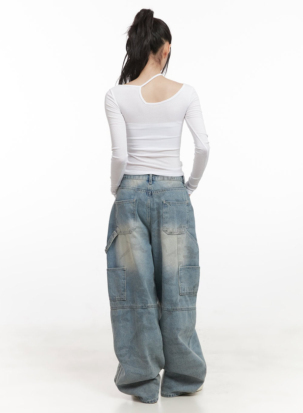 Abigail Camo-Print Carpenter Baggy Jeans CJ528 in blue, full back shot on model, oversized baggy fit with dual back pockets and carpenter utility pockets, washed camo denim, white asymmetric crop top.