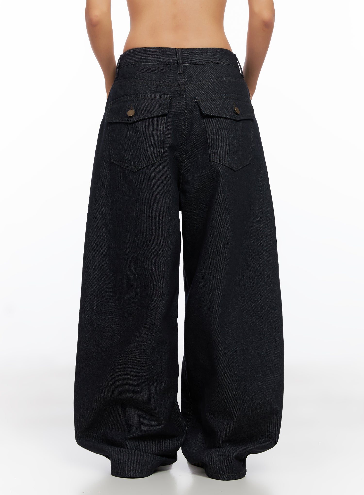 Miller Balloon Baggy Jeans CO515 in dark blue, back full-length view on model, wide balloon leg, flap back pockets with brass snaps, low rise waistband, hem pooling at floor.