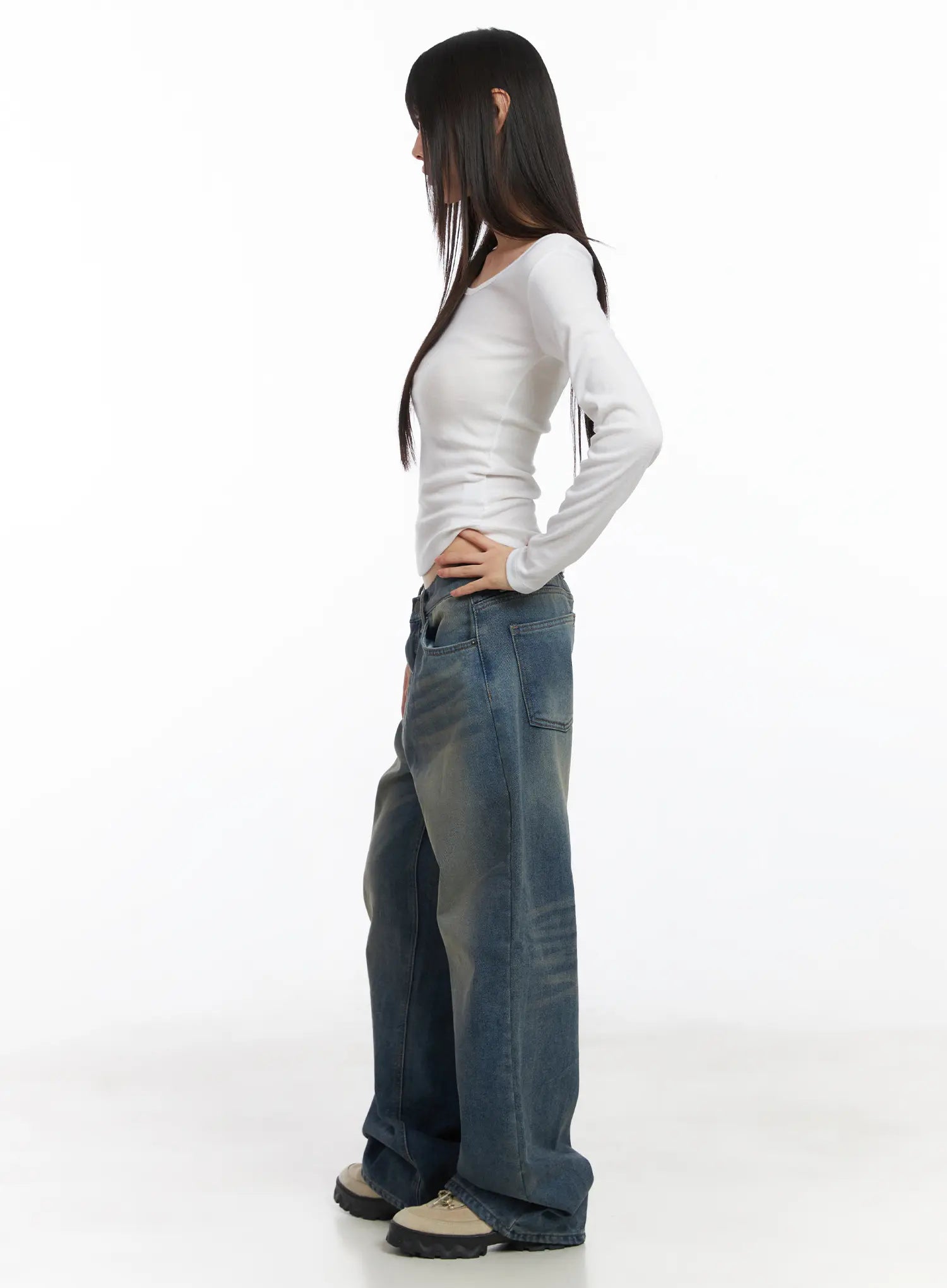 Miriam Wide Leg Jeans CD519 in blue, side full-length on model with hand on hip, washed wide-leg silhouette and front pocket detail visible, styled with white fitted top.
