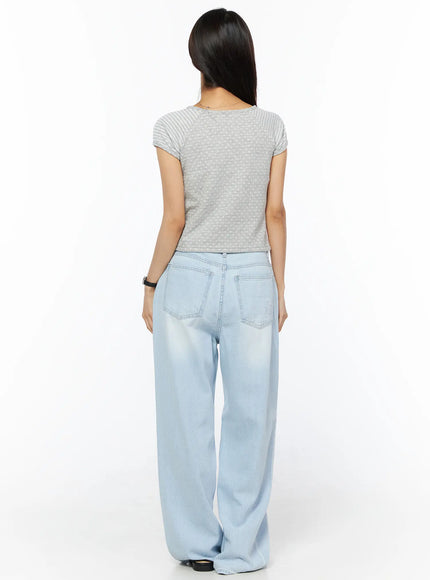 Rina Washed Wide-Leg Jeans CU522 in light blue, full-body back view on model, wide-leg silhouette with back pockets, styled with grey dotted crop tee and black sandals.