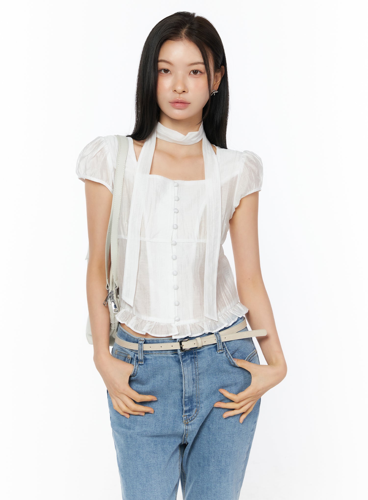 Puff Sleeve Shirred Blouse with Scarf IU519 in white, front view on model with crossbody bag strap, square neck button-front blouse with scarf and ruffled hem, styled with jeans and belt.